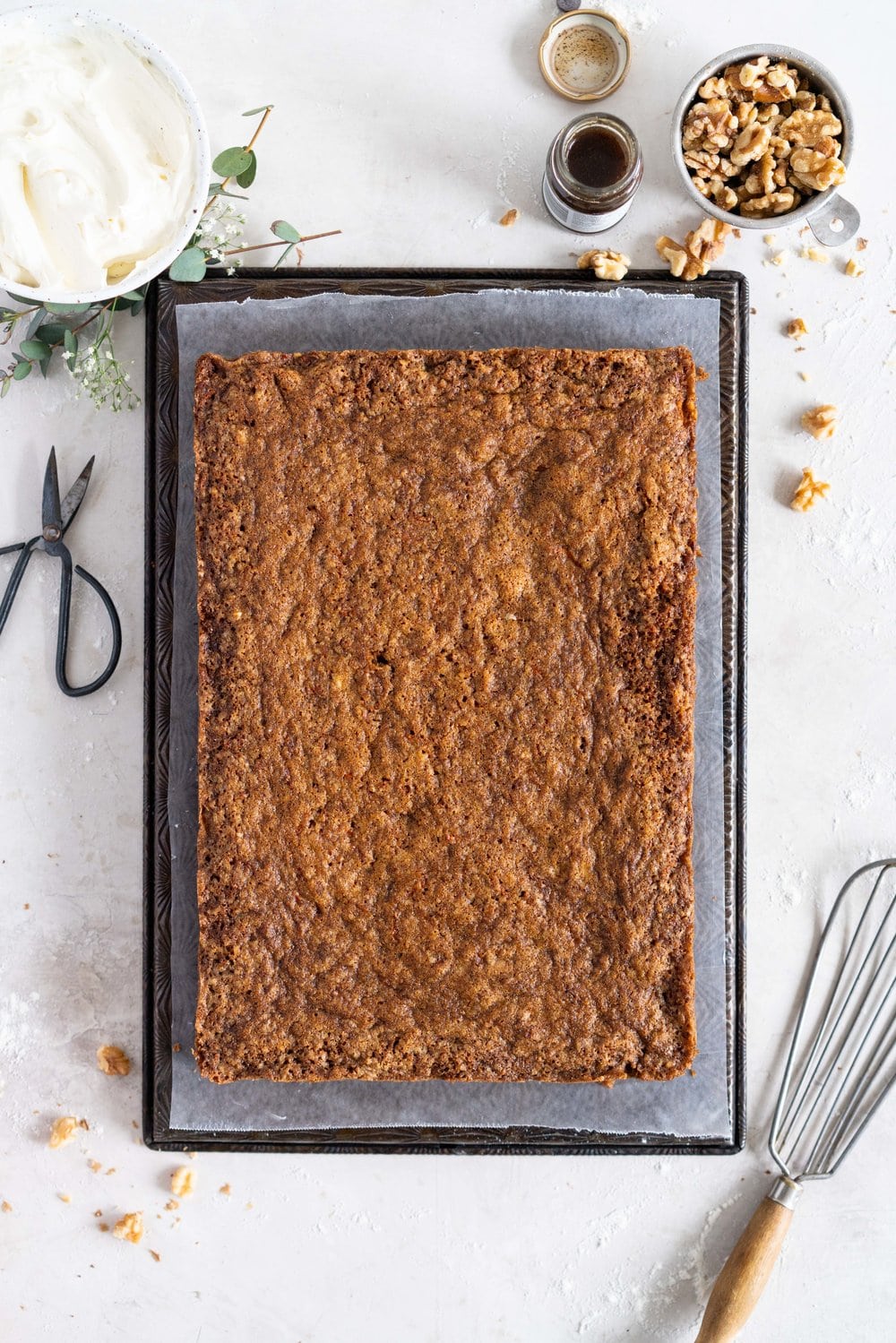 Brown Butter Carrot Sheet Cake is taken to the next level with a fluffy, whipped vanilla bean cream cheese german buttercream. This cake comes together super easily but is super delicious, and would make the perfect easter dessert. #brownbutter #carrotcake #sheetcake #germanbuttercream