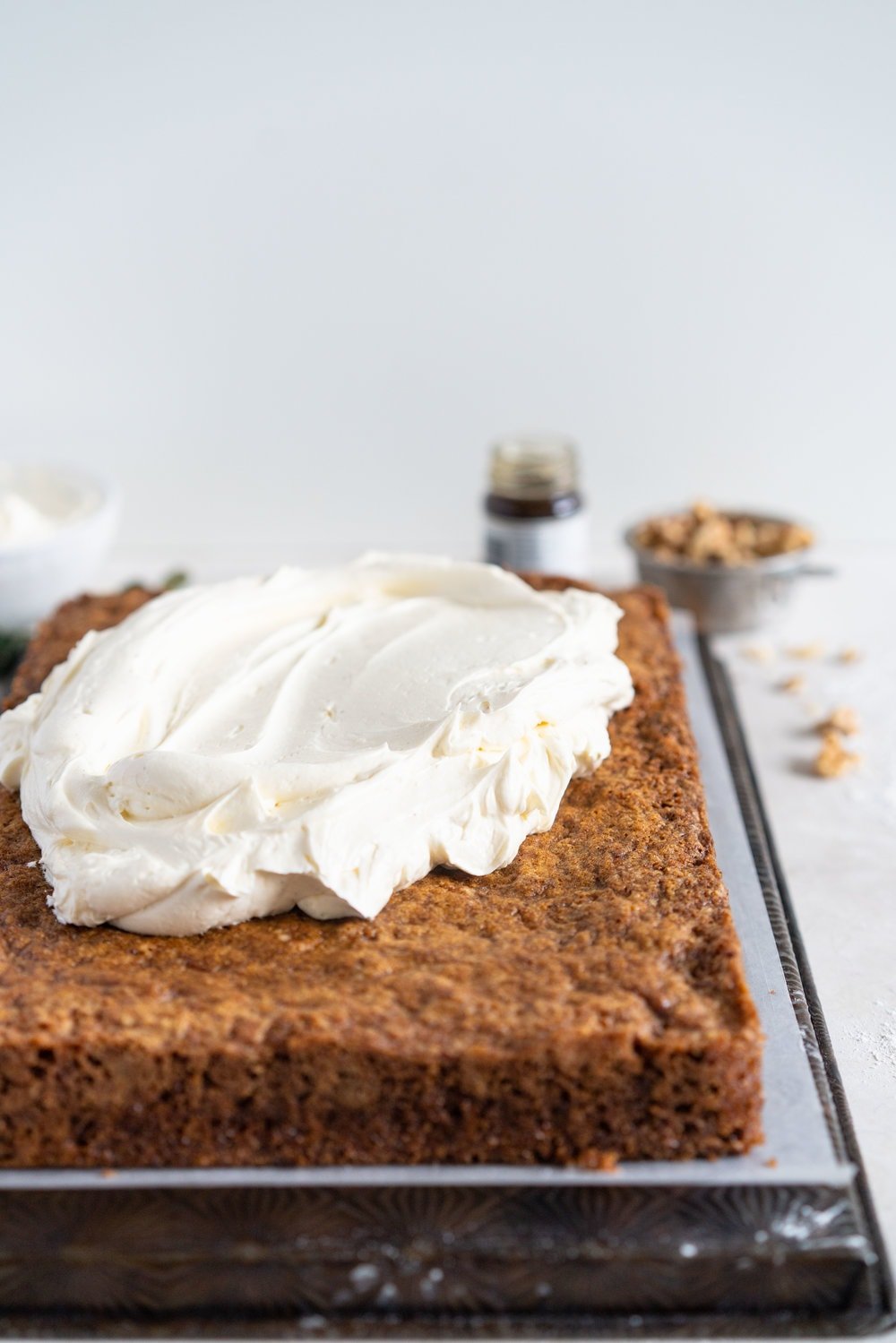 Brown Butter Carrot Sheet Cake is taken to the next level with a fluffy, whipped vanilla bean cream cheese german buttercream. This cake comes together super easily but is super delicious, and would make the perfect easter dessert. #brownbutter #carrotcake #sheetcake #germanbuttercream