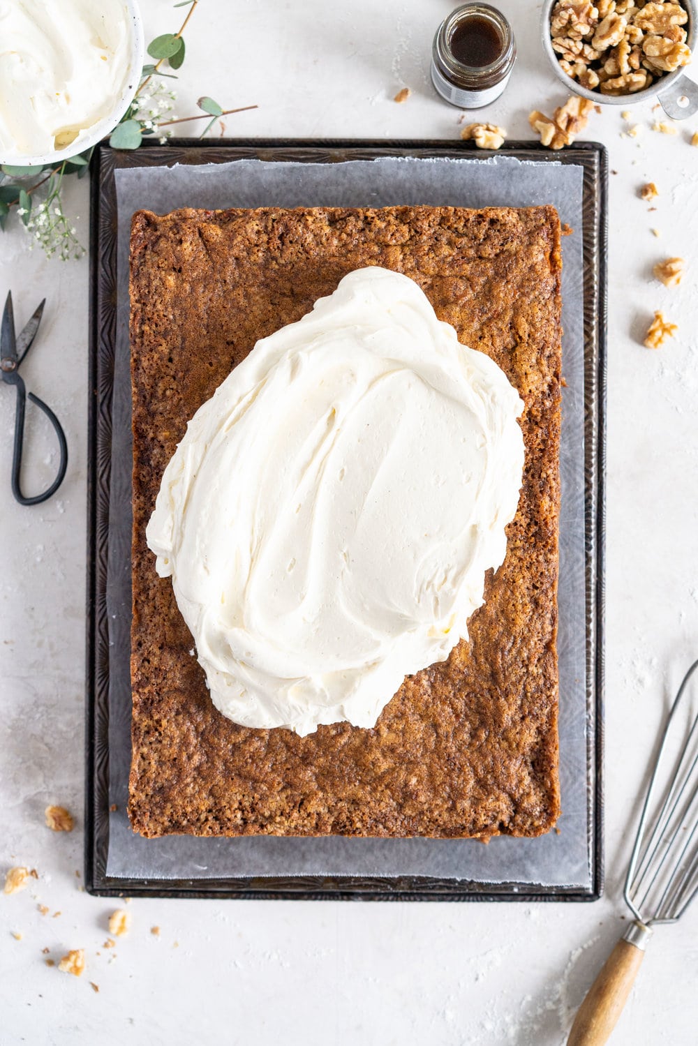 Brown Butter Carrot Sheet Cake is taken to the next level with a fluffy, whipped vanilla bean cream cheese german buttercream. This cake comes together super easily but is super delicious, and would make the perfect easter dessert. #brownbutter #carrotcake #sheetcake #germanbuttercream