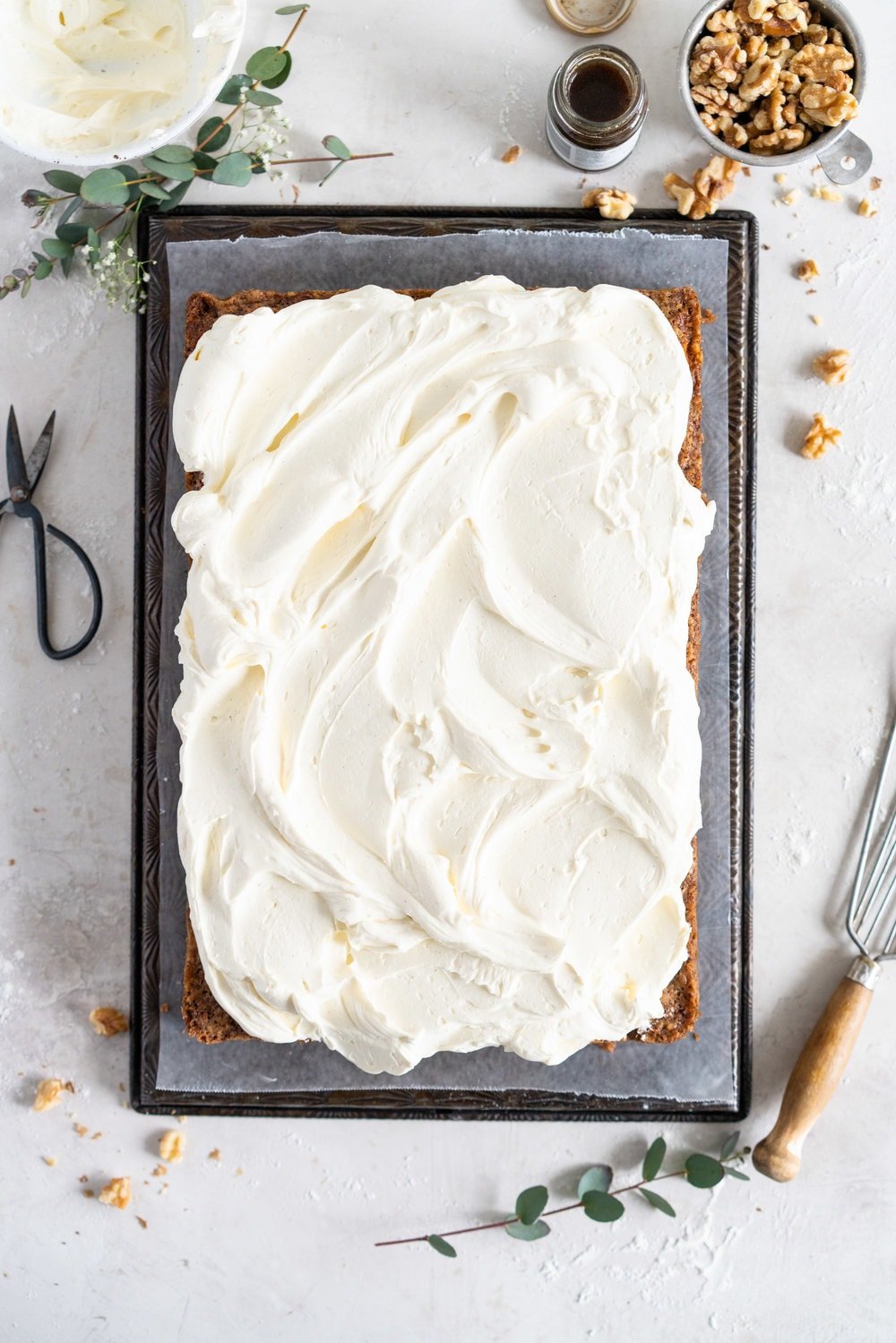 Brown Butter Carrot Sheet Cake is taken to the next level with a fluffy, whipped vanilla bean cream cheese german buttercream. This cake comes together super easily but is super delicious, and would make the perfect easter dessert. #brownbutter #carrotcake #sheetcake #germanbuttercream