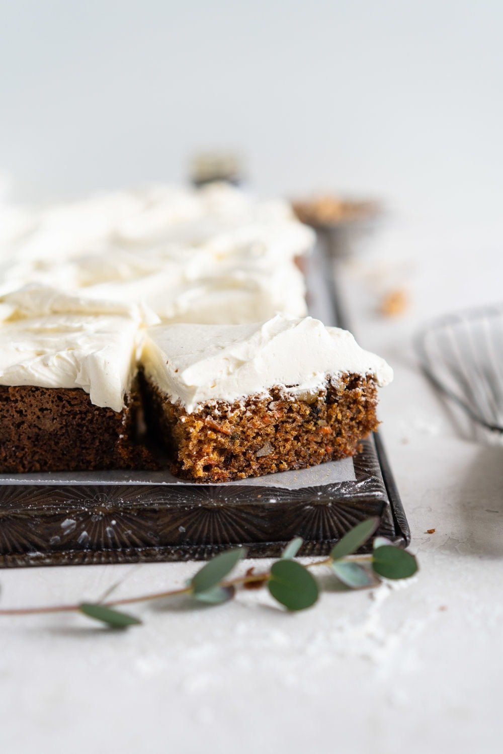 Brown Butter Carrot Sheet Cake is taken to the next level with a fluffy, whipped vanilla bean cream cheese german buttercream. This cake comes together super easily but is super delicious, and would make the perfect easter dessert. #brownbutter #carrotcake #sheetcake #germanbuttercream