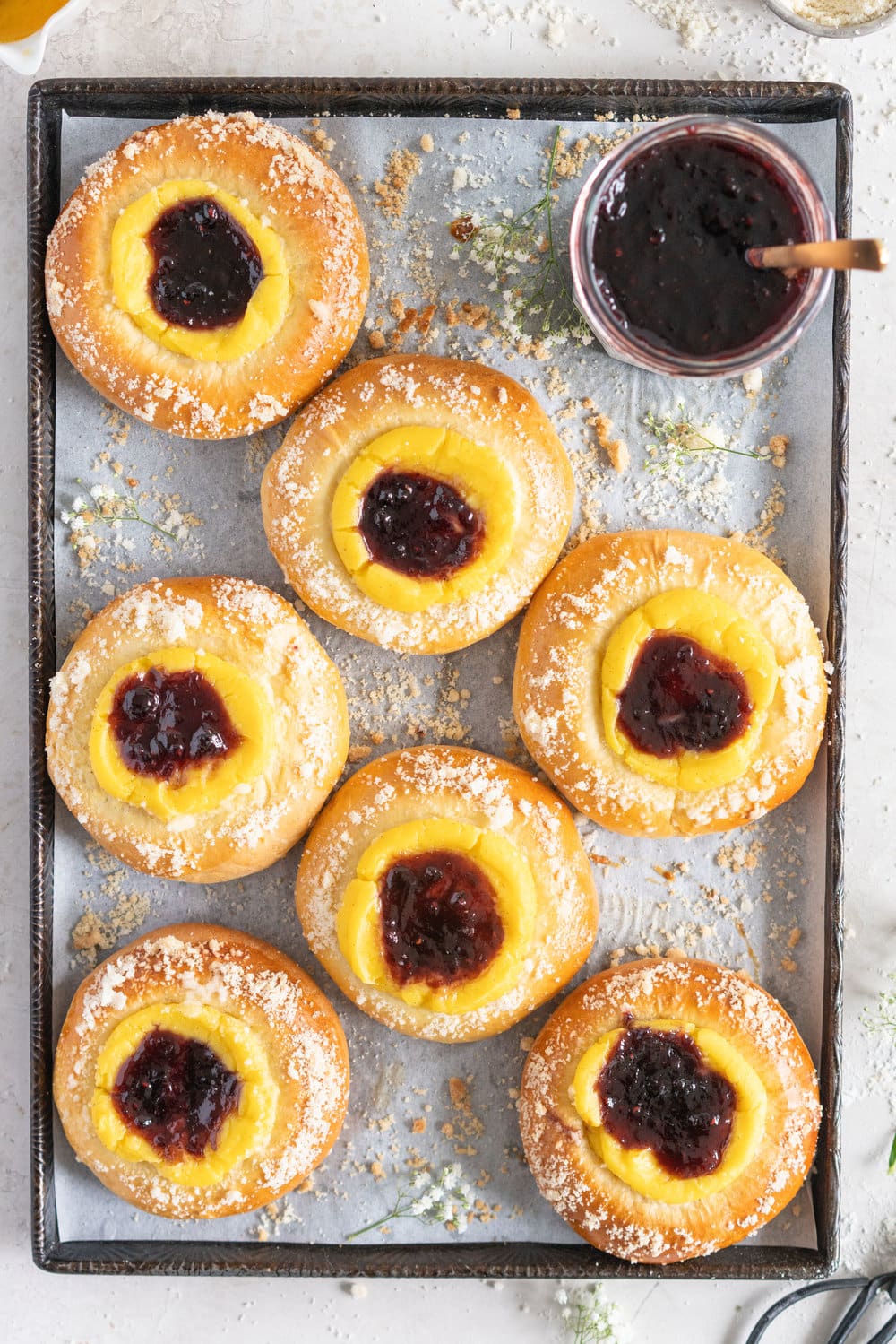 Custard Brioche Buns with Bonne Maman Mixed Berry Preserves and Vanilla bean Streusel. Light and fluffy brioche rounds are filled with a vanilla bean custard, then finished with a swirl of Bonne Maman Mixed berry preserves, and a sprinkle of vanilla bean streusel. These are perfect for a super easy but incredibly delicious brunch, as everything can be prepared the night before, making assembling the next morning super easy. #brioche #custardbun #breakfastpastry
