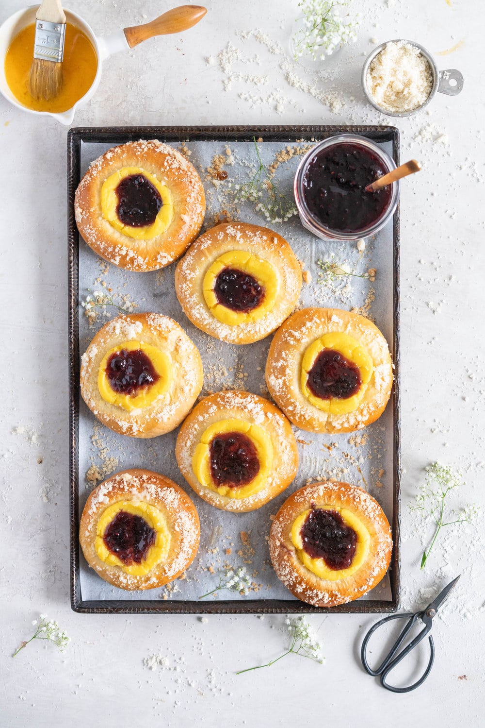 Custard Brioche Buns with Bonne Maman Mixed Berry Preserves and Vanilla bean Streusel. Light and fluffy brioche rounds are filled with a vanilla bean custard, then finished with a swirl of Bonne Maman Mixed berry preserves, and a sprinkle of vanilla bean streusel. These are perfect for a super easy but incredibly delicious brunch, as everything can be prepared the night before, making assembling the next morning super easy. #brioche #custardbun #breakfastpastry