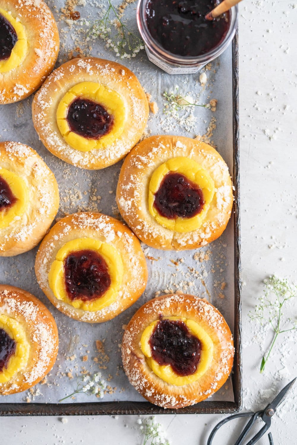 Custard Brioche Buns with Bonne Maman Mixed Berry Preserves and Vanilla bean Streusel. Light and fluffy brioche rounds are filled with a vanilla bean custard, then finished with a swirl of Bonne Maman Mixed berry preserves, and a sprinkle of vanilla bean streusel. These are perfect for a super easy but incredibly delicious brunch, as everything can be prepared the night before, making assembling the next morning super easy. #brioche #custardbun #breakfastpastry