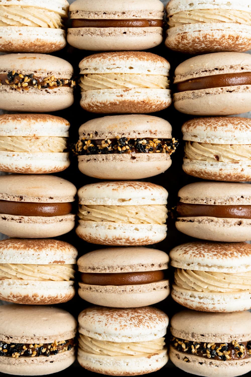 Sesame Macarons Two Ways - Chocolate Macarons with Salted Caramel Tahini Milk Chocolate Ganache and Sesame Brittle, and Vanilla Bean Macarons with Coffee German Buttercream and Halva. These two 'variations on a theme' show off the amazing versatility of tahini - a silky tahini chocolate ganache, and a halva stuffed macaron. #frenchmacarons #glutenfree #macarons