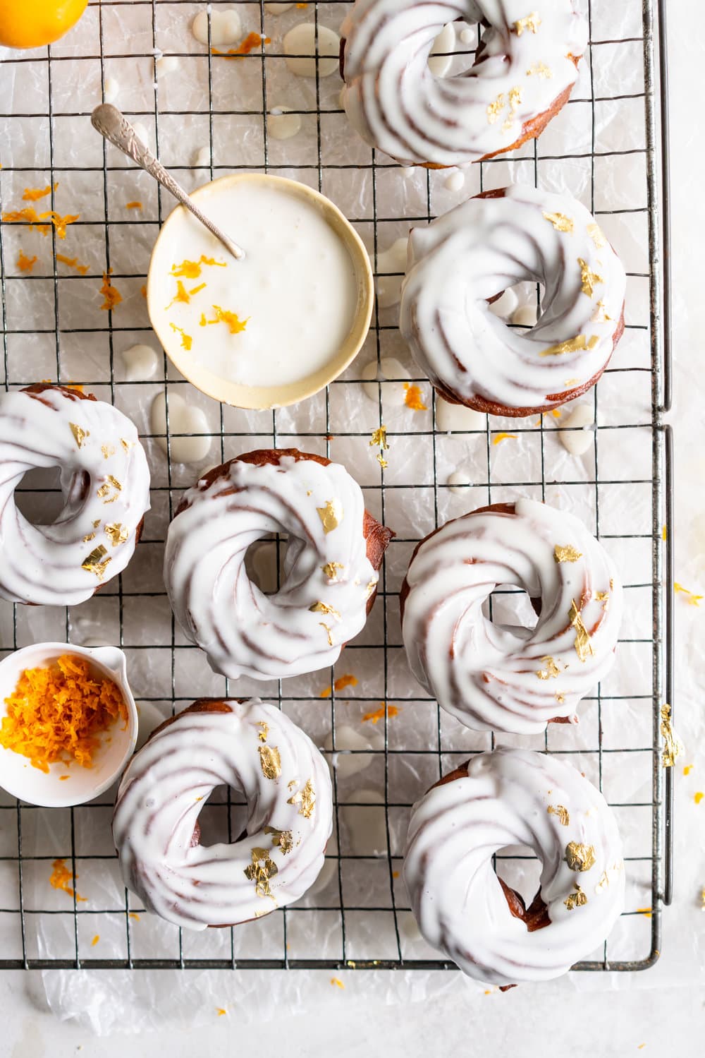 Lemon Crullers with Lemon and Honey Glaze - Fluffy, crispy lemon scented crullers are dipped in a lemon and honey glaze and finished with delicate gold leaf. Crullers are made by frying choux dough, and are a must-try if you haven't made them before! #crullers #doughnut #lemoncruller