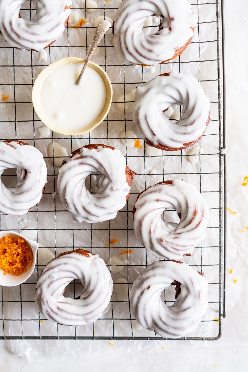 Lemon Crullers with Lemon and Honey Glaze - Fluffy, crispy lemon scented crullers are dipped in a lemon and honey glaze and finished with delicate gold leaf. Crullers are made by frying choux dough, and are a must-try if you haven't made them before! #crullers #doughnut #lemoncruller