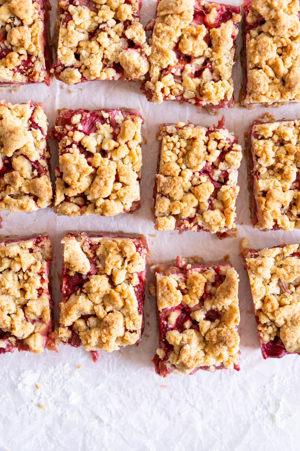 Brown Butter Hazelnut Strawberry Rhubarb Crumb Bars - a brown butter hazelnut shortbread is used as both the base and the crumble topping for these strawberry rhubarb crumb bars. These are the perfect early summer easy dessert! #crumbbars #strawberryrhubarb #brownbutter