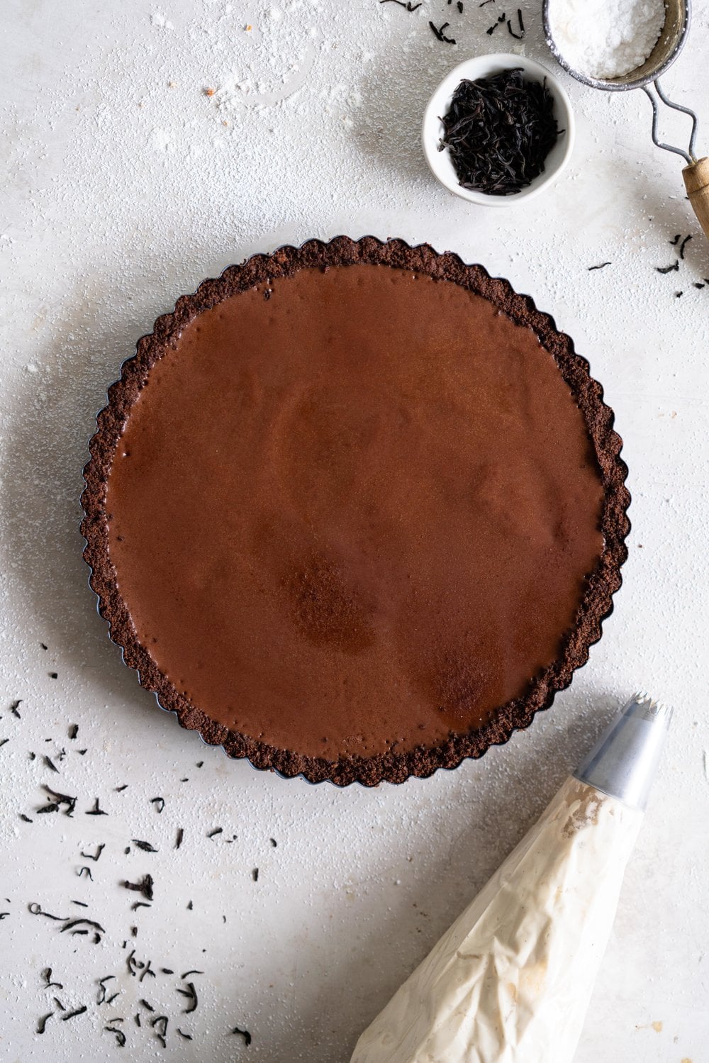 Dark Chocolate Salted Caramel Ganache Tart with Chocolate Graham Cracker Crust and Earl Grey Mascarpone Whipped Cream - this chocolate tart comes together quickly, and is the perfect easy dessert that easily feeds a crowd. A crunch base is topped with a silky smooth chocolate salted caramel filling, and finished with an earl grey mascarpone whipped cream. #chocolatetart #saltedcaramel #earlgreywhippedcream