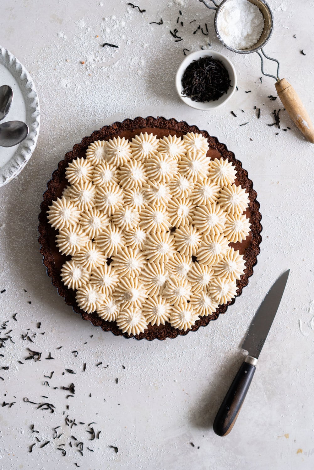 Dark Chocolate Salted Caramel Ganache Tart with Chocolate Graham Cracker Crust and Earl Grey Mascarpone Whipped Cream - this chocolate tart comes together quickly, and is the perfect easy dessert that easily feeds a crowd. A crunch base is topped with a silky smooth chocolate salted caramel filling, and finished with an earl grey mascarpone whipped cream. #chocolatetart #saltedcaramel #earlgreywhippedcream