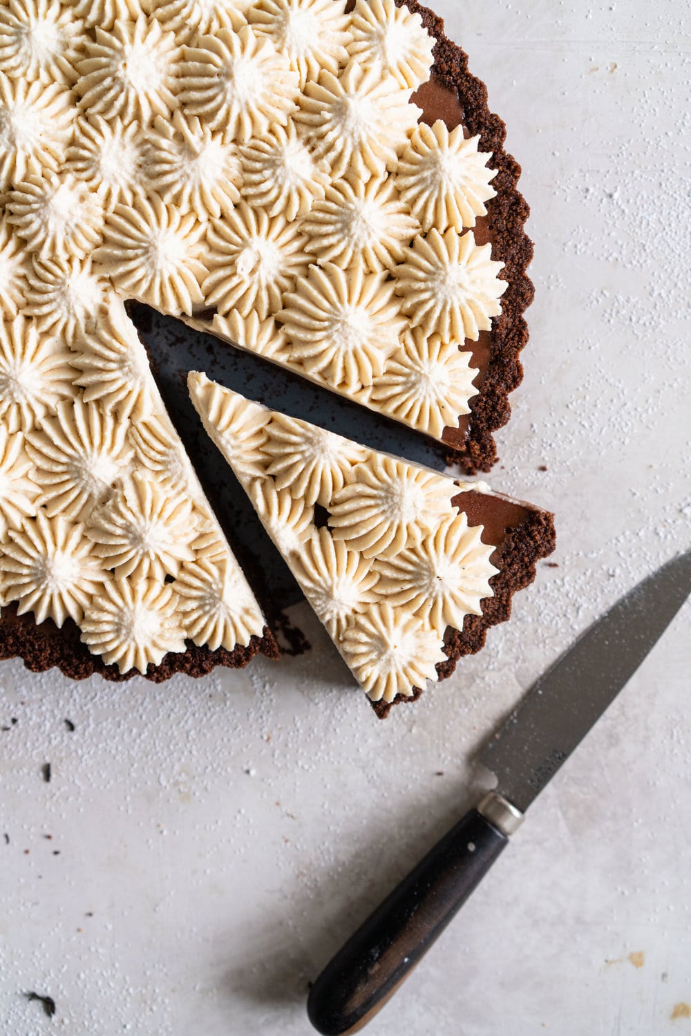 Dark Chocolate Salted Caramel Ganache Tart with Chocolate Graham Cracker Crust and Earl Grey Mascarpone Whipped Cream - this chocolate tart comes together quickly, and is the perfect easy dessert that easily feeds a crowd. A crunch base is topped with a silky smooth chocolate salted caramel filling, and finished with an earl grey mascarpone whipped cream. #chocolatetart #saltedcaramel #earlgreywhippedcream