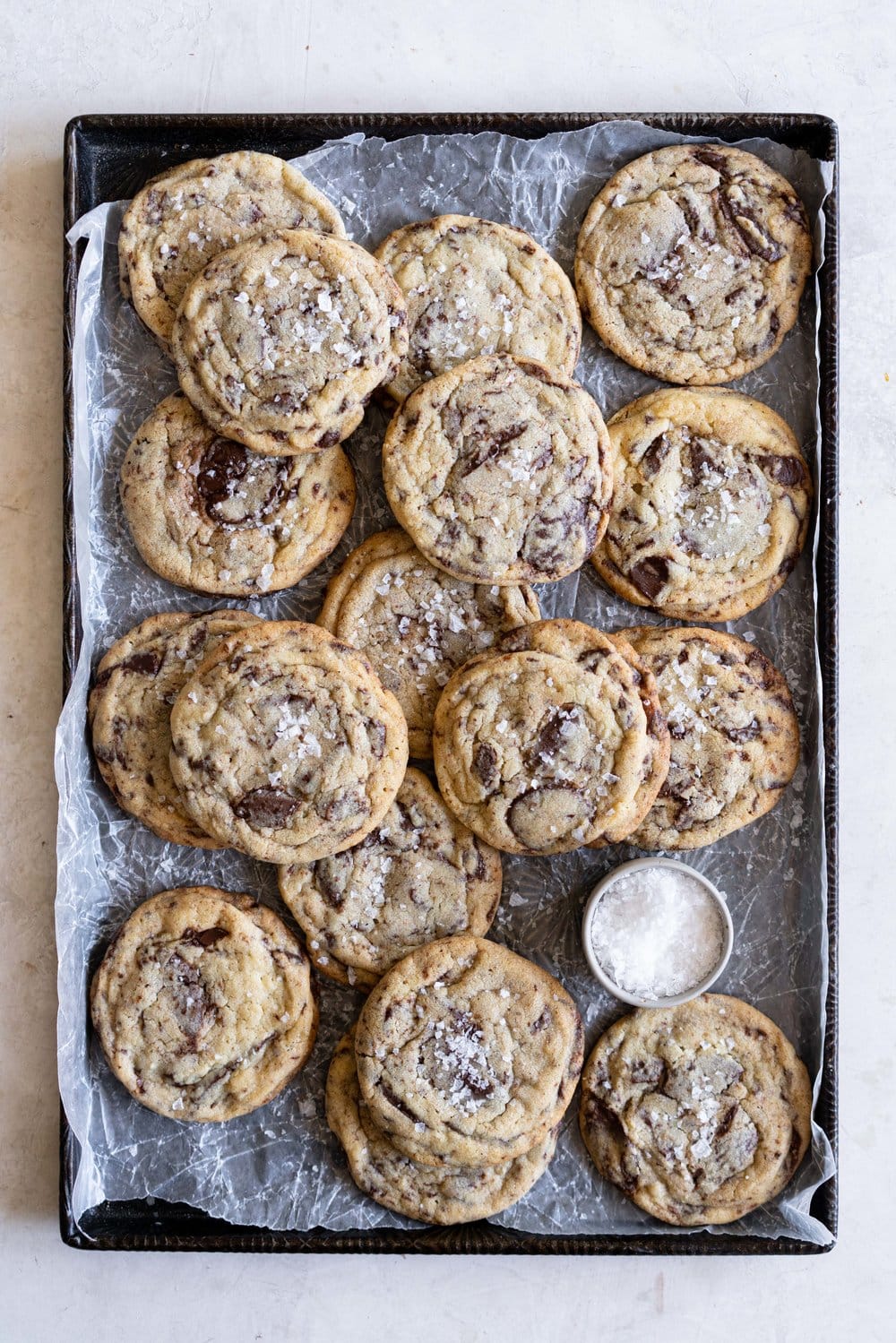 Chocolate Chip Cookie Ice Cream Sandwiches with Olive Oil Ice Cream. Thin and crispy chocolate chip cookies sandwich a creamy, smooth disc of olive oil ice cream. The perfect summer treat. #oliveoilicecream #icecreamsandwich #chocolatechipcookie
