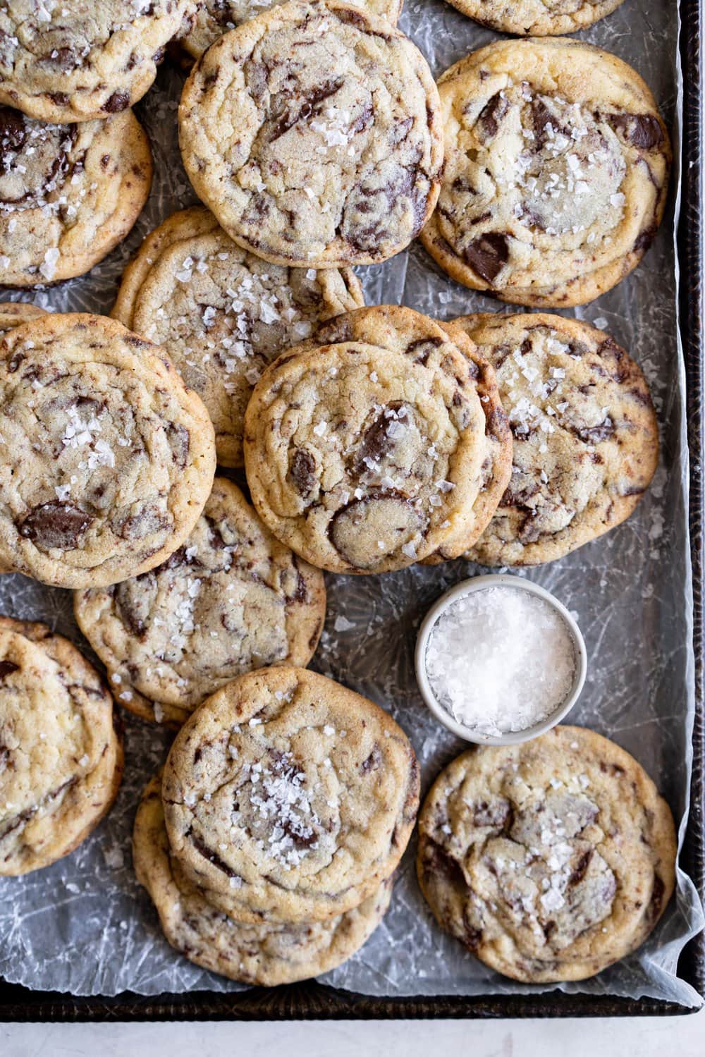 Chocolate Chip Cookie Ice Cream Sandwiches with Olive Oil Ice Cream. Thin and crispy chocolate chip cookies sandwich a creamy, smooth disc of olive oil ice cream. The perfect summer treat. #oliveoilicecream #icecreamsandwich #chocolatechipcookie