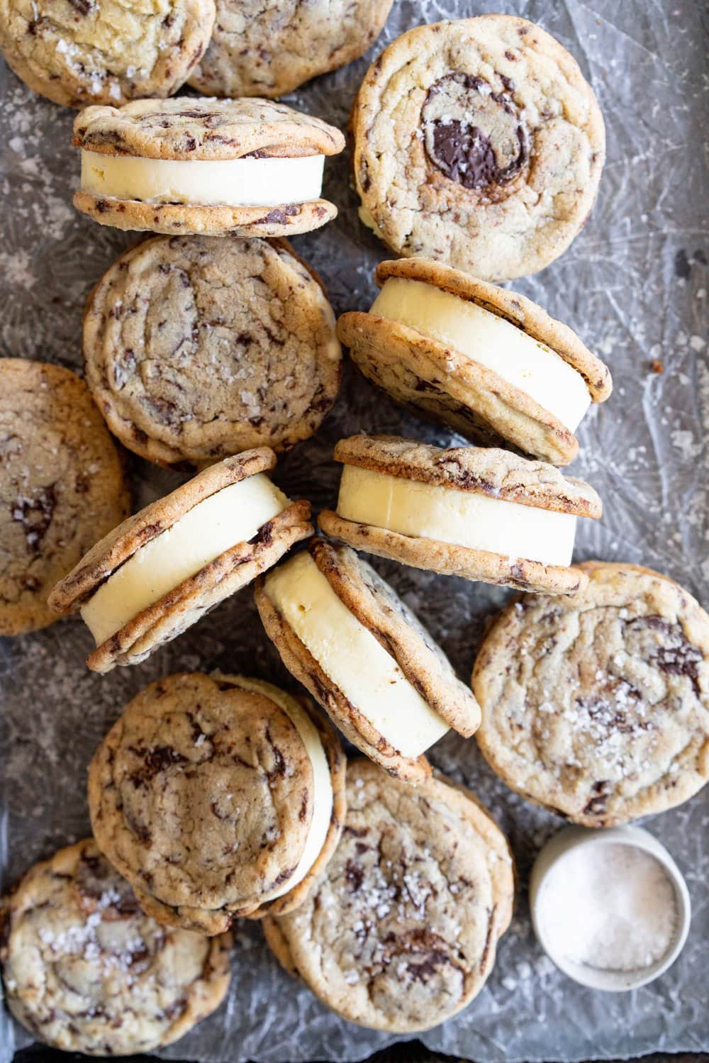 Chocolate Chip Cookie Ice Cream Sandwiches with Olive Oil Ice Cream. Thin and crispy chocolate chip cookies sandwich a creamy, smooth disc of olive oil ice cream. The perfect summer treat. #oliveoilicecream #icecreamsandwich #chocolatechipcookie