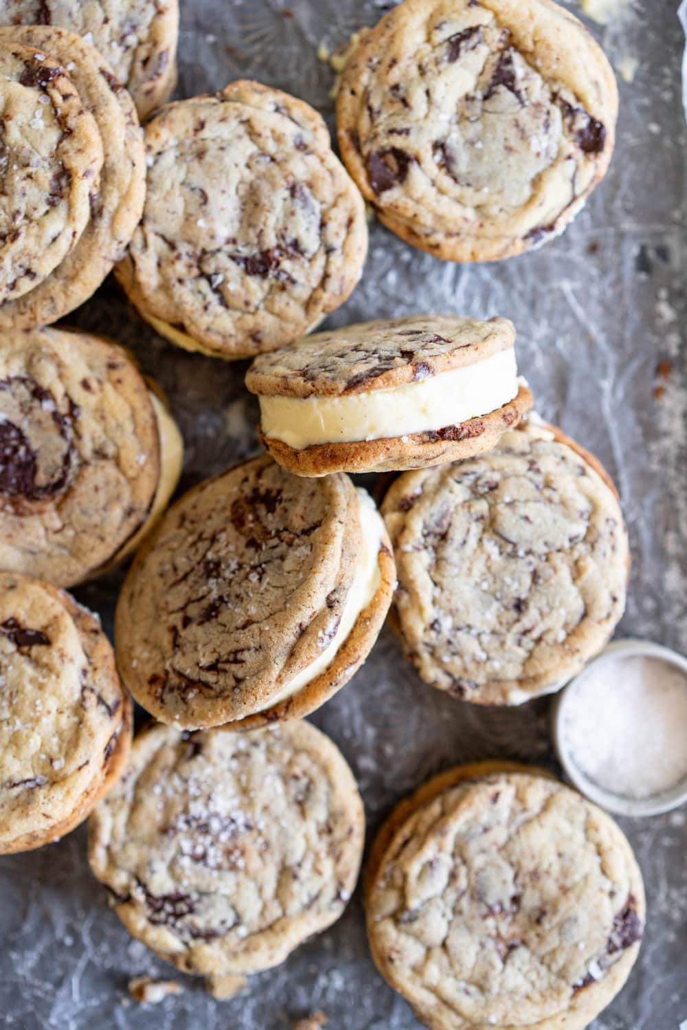 Chocolate Chip Cookie Ice Cream Sandwiches with Olive Oil Ice Cream. Thin and crispy chocolate chip cookies sandwich a creamy, smooth disc of olive oil ice cream. The perfect summer treat. #oliveoilicecream #icecreamsandwich #chocolatechipcookie