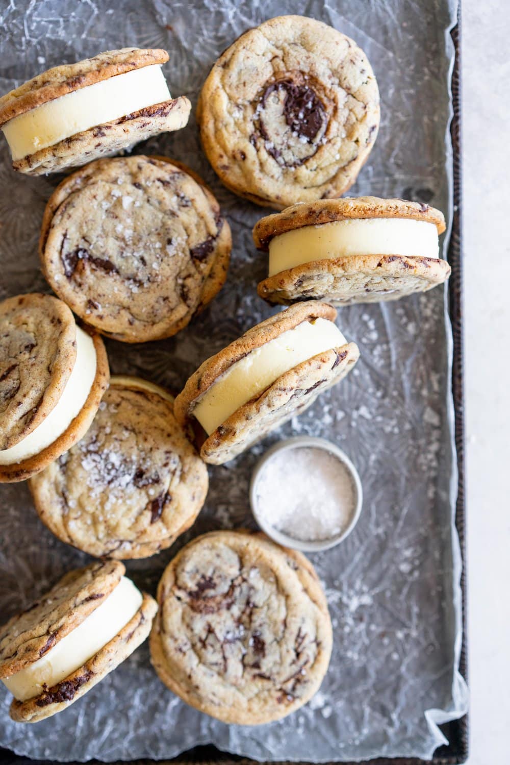Chocolate Chip Cookie Ice Cream Sandwiches with Olive Oil Ice Cream. Thin and crispy chocolate chip cookies sandwich a creamy, smooth disc of olive oil ice cream. The perfect summer treat. #oliveoilicecream #icecreamsandwich #chocolatechipcookie