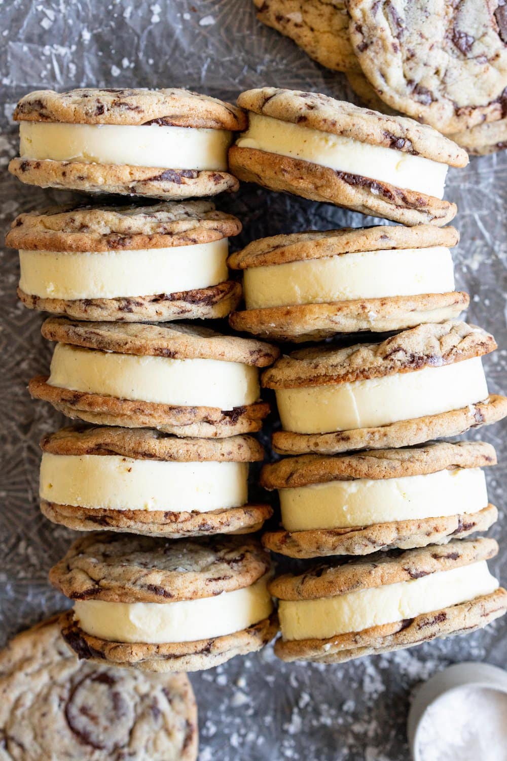 Chocolate Chip Cookie Ice Cream Sandwiches with Olive Oil Ice Cream. Thin and crispy chocolate chip cookies sandwich a creamy, smooth disc of olive oil ice cream. The perfect summer treat. #oliveoilicecream #icecreamsandwich #chocolatechipcookie