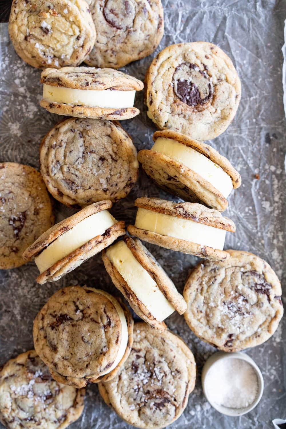 Chocolate Chip Cookie Ice Cream Sandwiches with Olive Oil Ice Cream. Thin and crispy chocolate chip cookies sandwich a creamy, smooth disc of olive oil ice cream. The perfect summer treat. #oliveoilicecream #icecreamsandwich #chocolatechipcookie