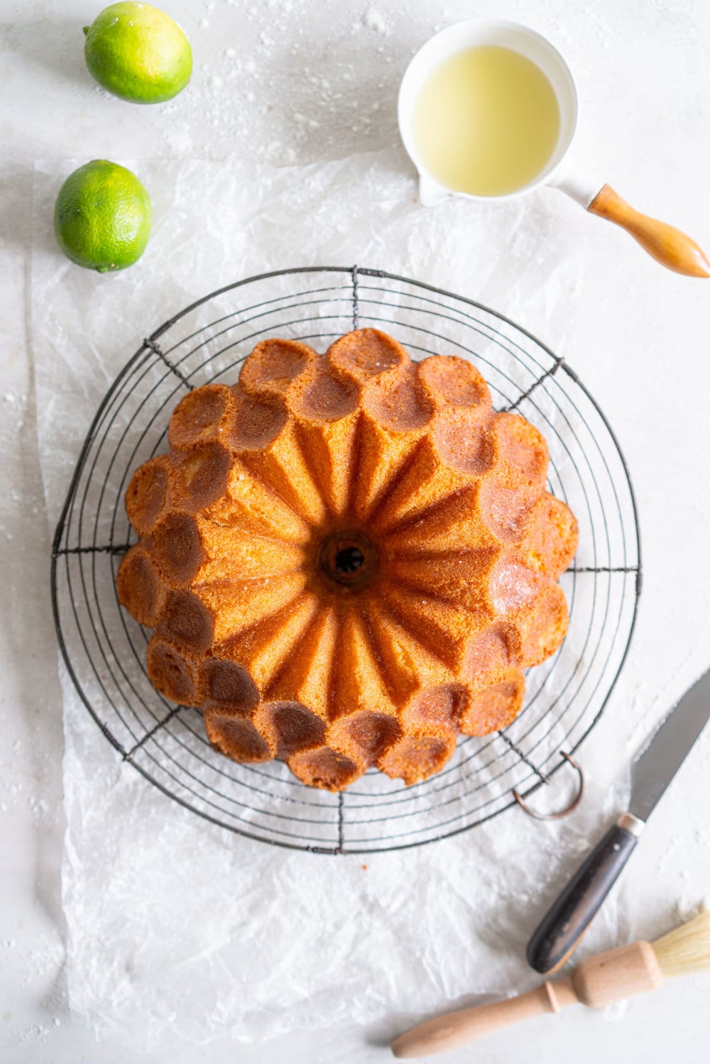 Maida Heatter's East 62nd Street Lemon Cake (Lemon and Lime Bundt Cake). This recipe comes from the legendary Maida Heatter's latest book, Happiness is baking. It is a tender crumbed lemon cake, brushed with a crunchy sugary glaze. Incredibly easy and so, so delicious. #maidaheatter #lemoncake #bundtcake