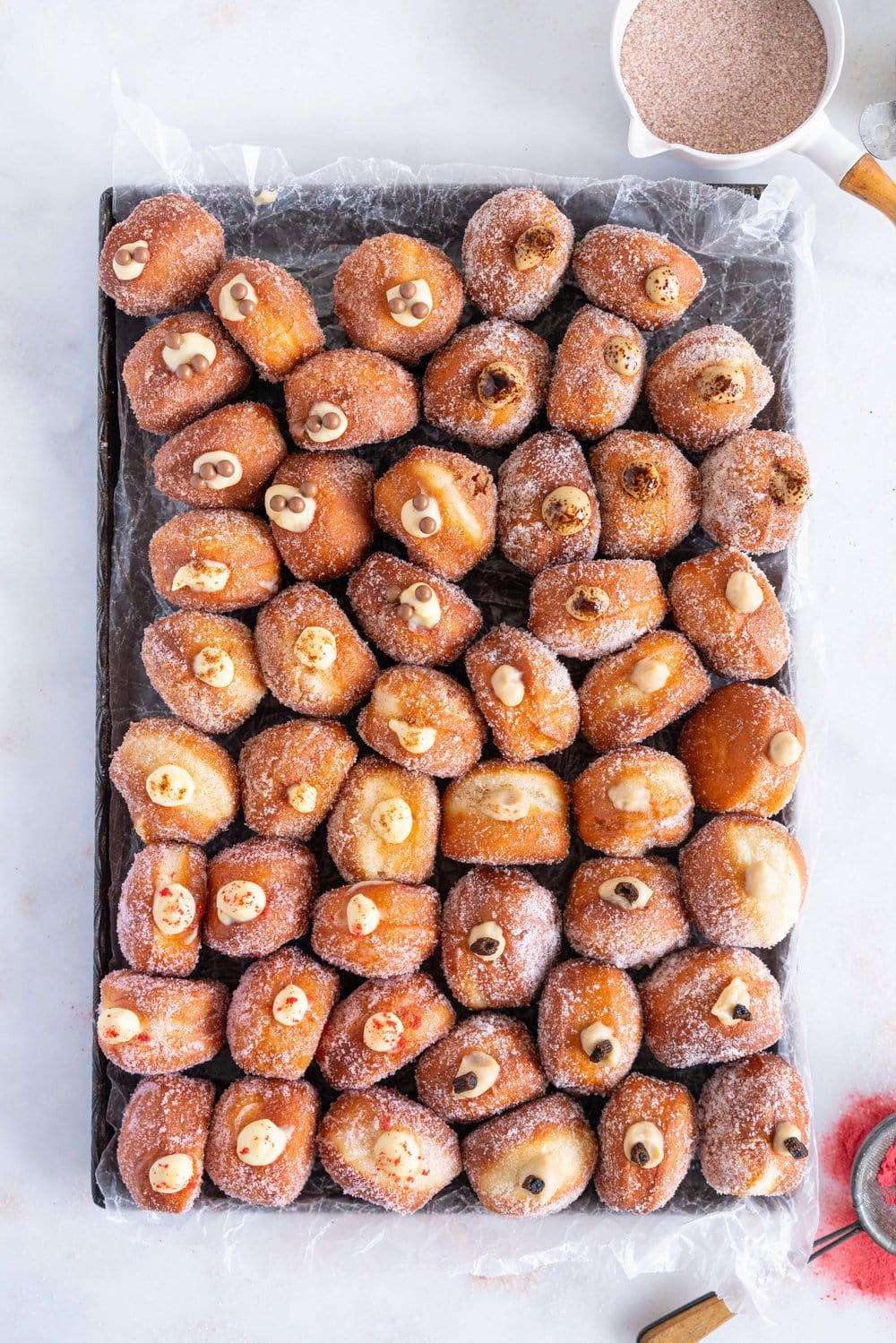 Perfectly fluffy mini brioche doughnuts are fried to perfection, rolled in sugar, and filled with flavoured pastry cream. A whole tray of mini doughnuts would be perfect for a special occasion or gathering, as they are a hit with all ages! #doughnut #briochedoughnut