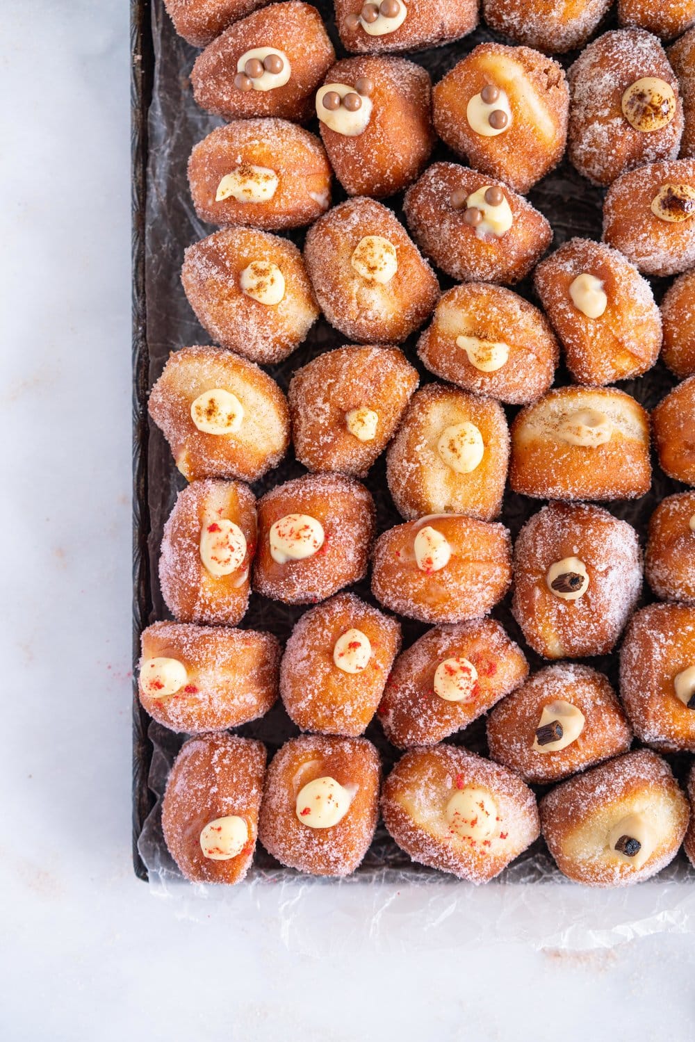 Perfectly fluffy mini brioche doughnuts are fried to perfection, rolled in sugar, and filled with flavoured pastry cream. A whole tray of mini doughnuts would be perfect for a special occasion or gathering, as they are a hit with all ages! #doughnut #briochedoughnut