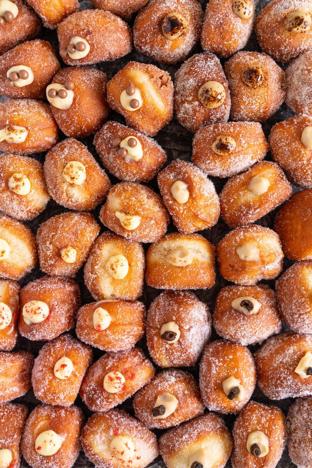 Perfectly fluffy mini brioche doughnuts are fried to perfection, rolled in sugar, and filled with flavoured pastry cream. A whole tray of mini doughnuts would be perfect for a special occasion or gathering, as they are a hit with all ages! #doughnut #briochedoughnut