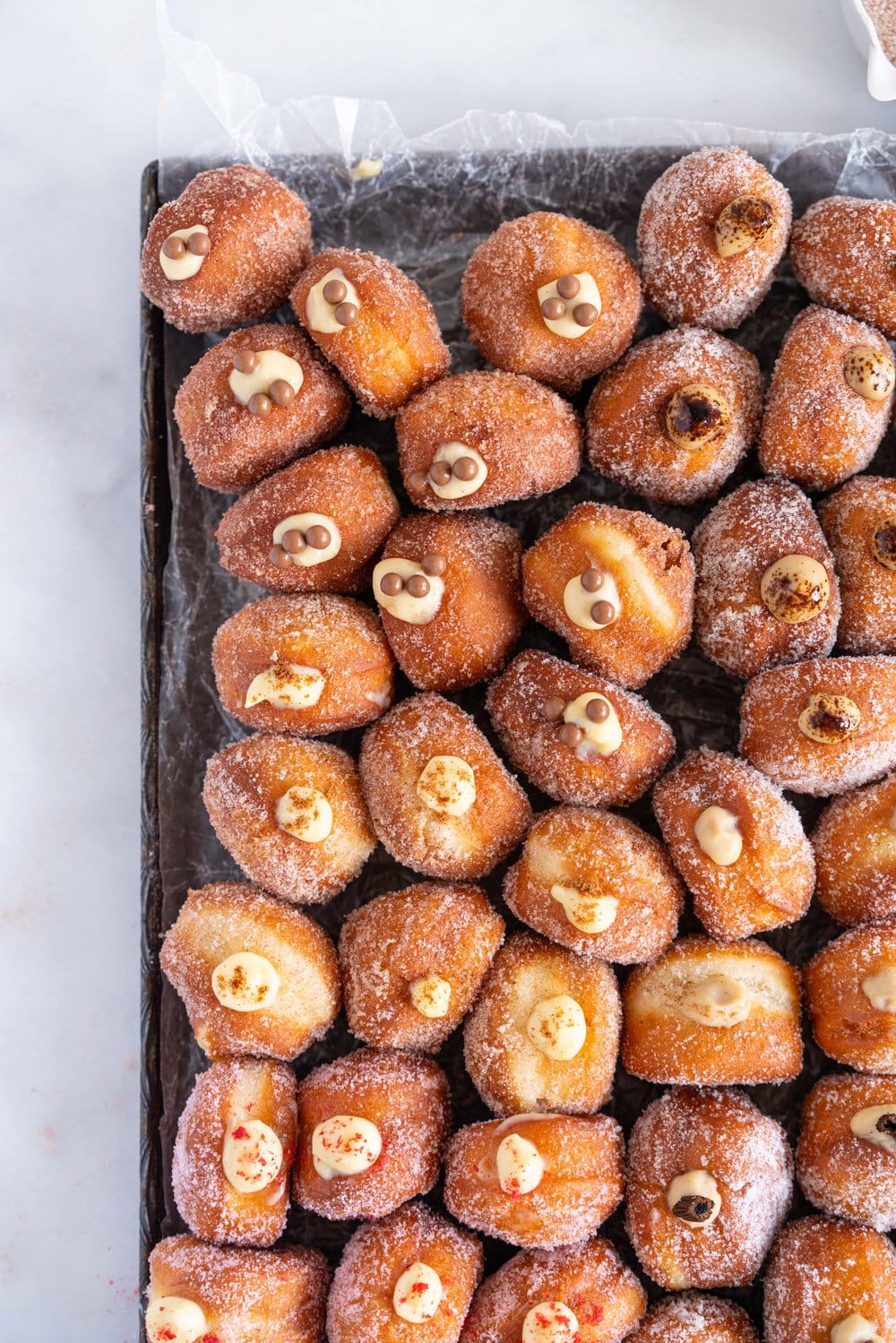 Perfectly fluffy mini brioche doughnuts are fried to perfection, rolled in sugar, and filled with flavoured pastry cream. A whole tray of mini doughnuts would be perfect for a special occasion or gathering, as they are a hit with all ages! #doughnut #briochedoughnut
