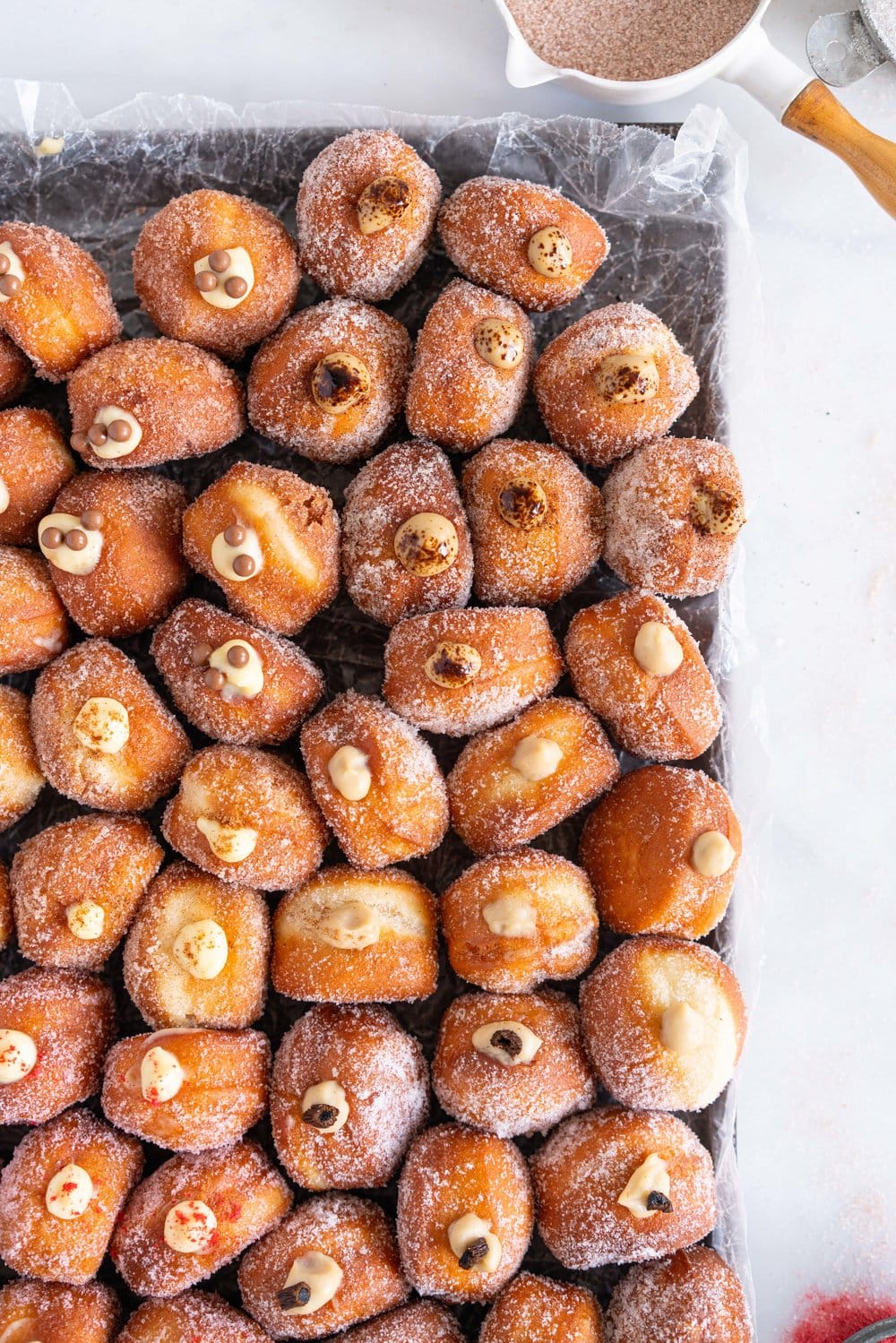 Perfectly fluffy mini brioche doughnuts are fried to perfection, rolled in sugar, and filled with flavoured pastry cream. A whole tray of mini doughnuts would be perfect for a special occasion or gathering, as they are a hit with all ages! #doughnut #briochedoughnut