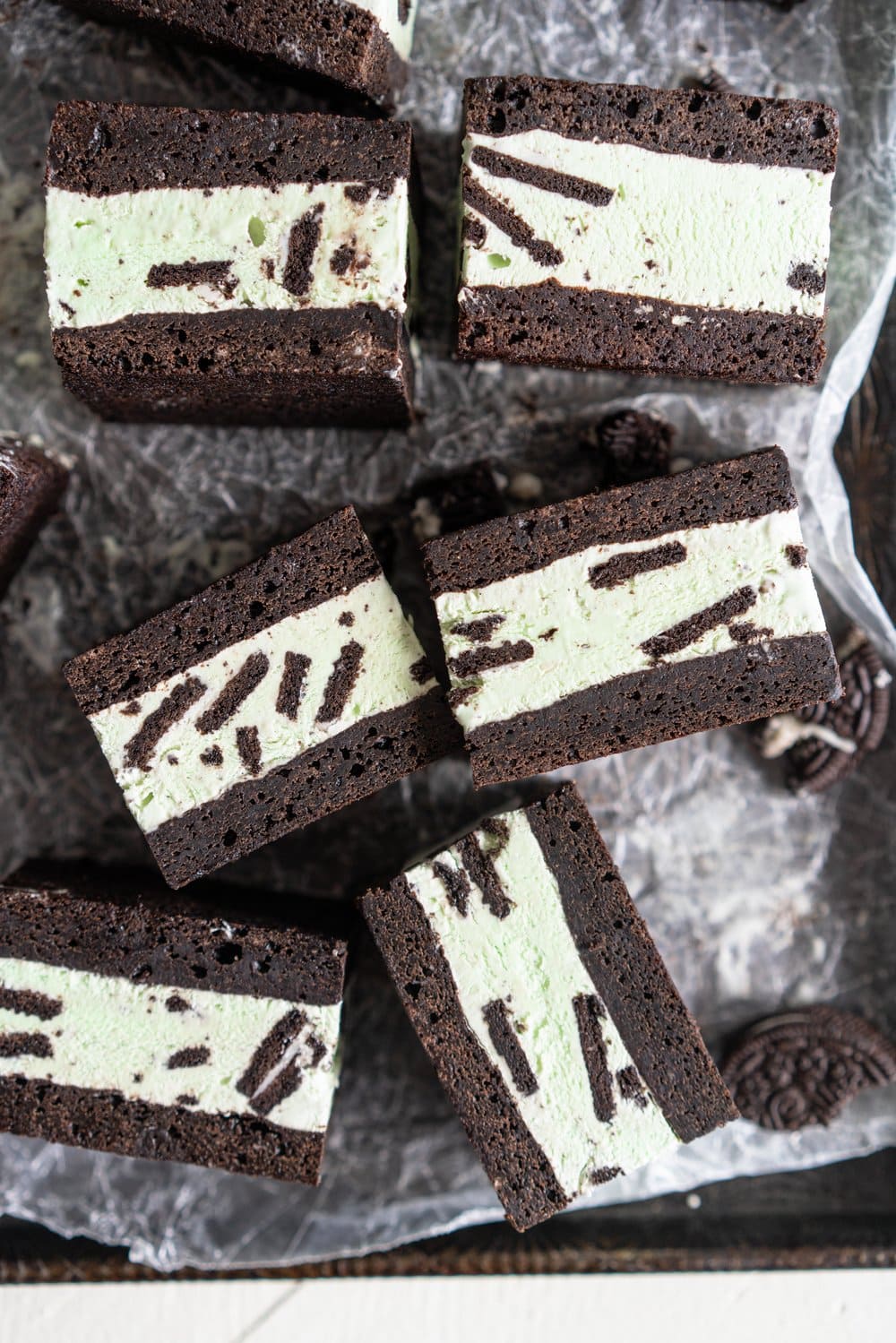 Black cocoa brownie ice cream sandwiches - black cocoa brownies are baked thin and fudgy, then layered up with smooth oreo mint philadelphia style ice cream. These are the perfect summer treat and great for feeding a crowd, you can't go wrong with a good brownie ice cream sandwich. #brownie #icecreamsandwich #mintchip #philadelphiaicecream