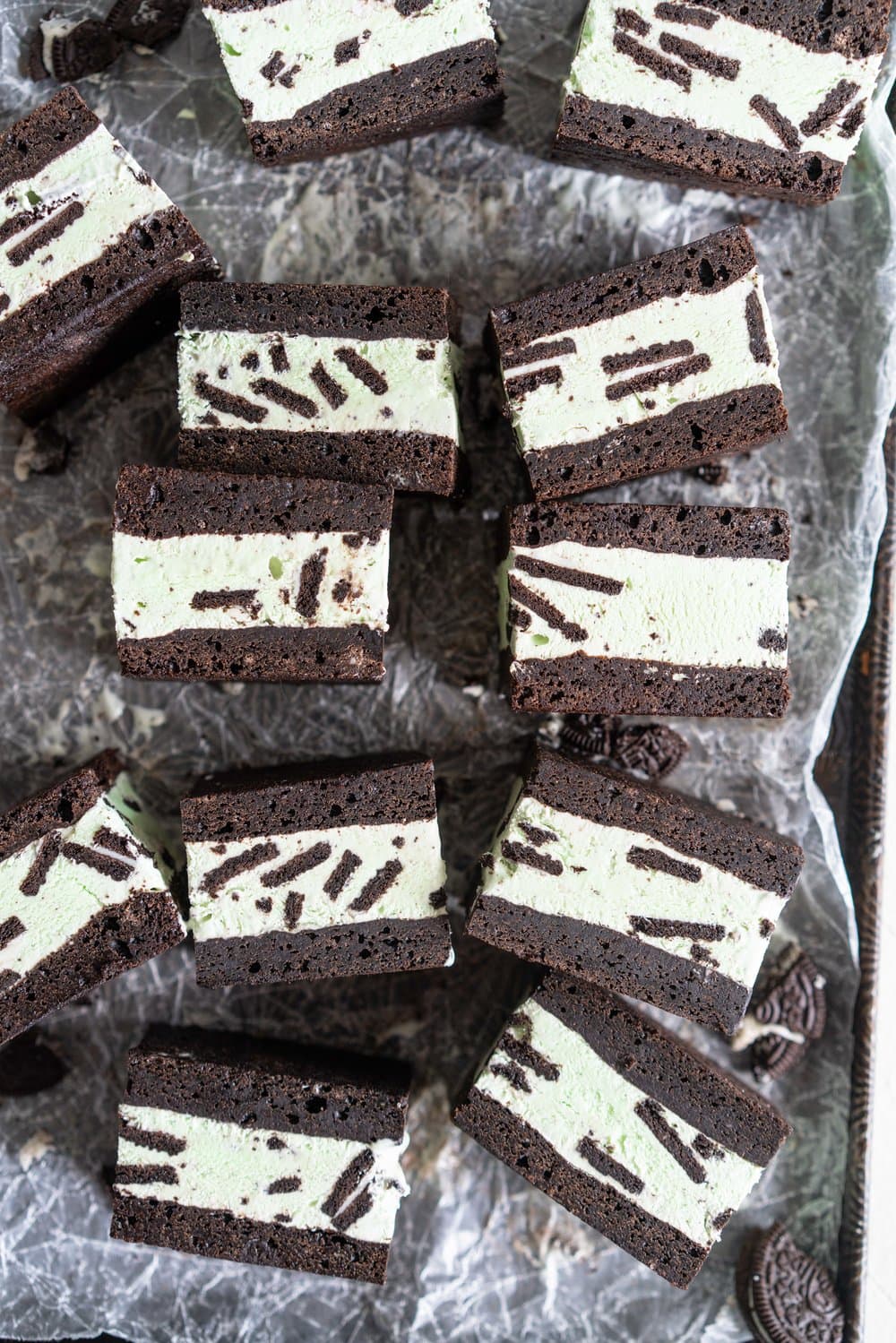 Black cocoa brownie ice cream sandwiches - black cocoa brownies are baked thin and fudgy, then layered up with smooth oreo mint philadelphia style ice cream. These are the perfect summer treat and great for feeding a crowd, you can't go wrong with a good brownie ice cream sandwich. #brownie #icecreamsandwich #mintchip #philadelphiaicecream