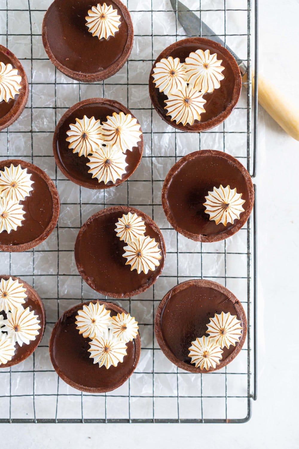 Dark Chocolate Peanut Butter Mini Tarts with Mixed Berry Jam, Chocolate Crust, and Torched Swiss Meringue #minitart #peanutbutterganache #chocolatetart