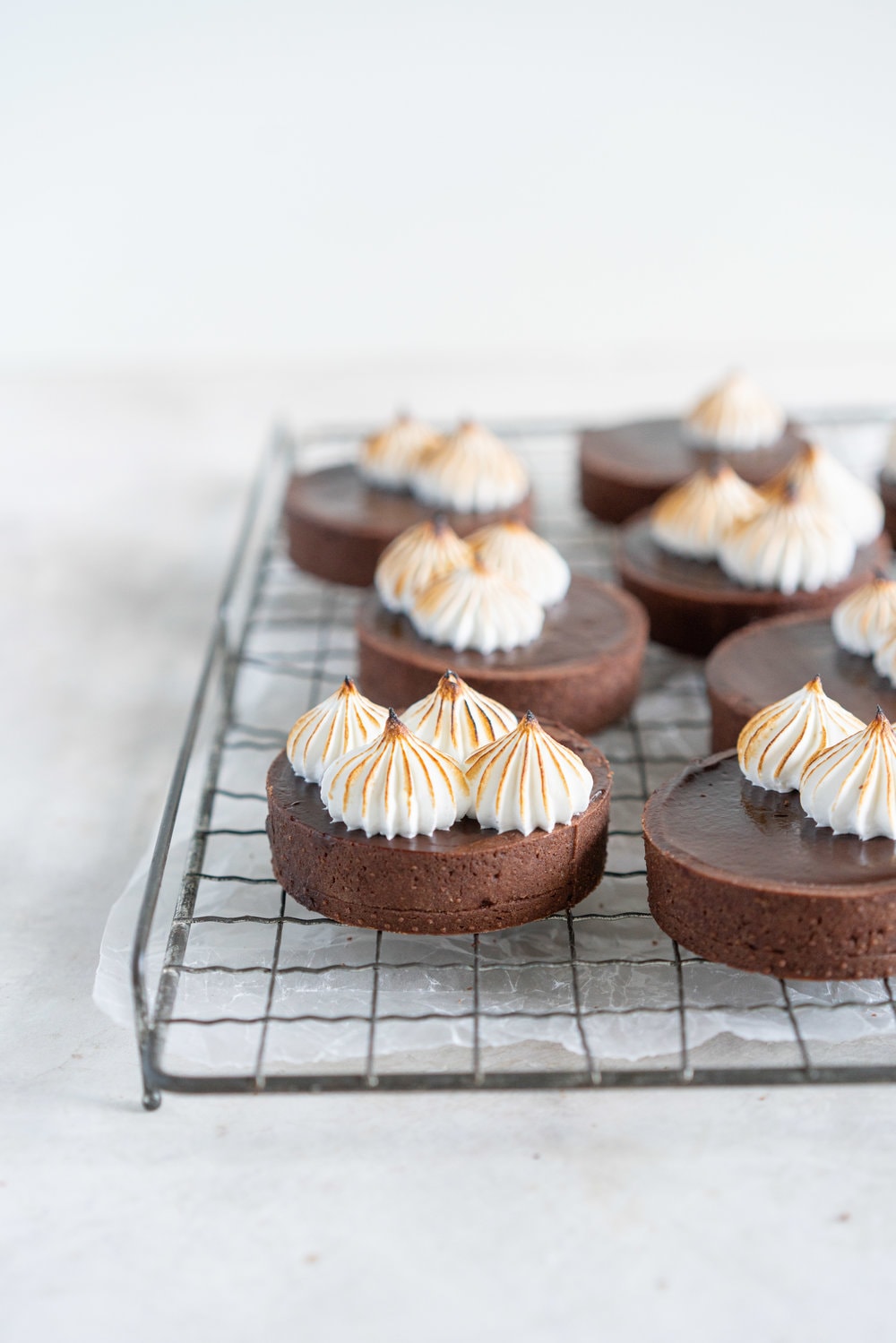 Dark Chocolate Peanut Butter Mini Tarts with Mixed Berry Jam, Chocolate Crust, and Torched Swiss Meringue #minitart #peanutbutterganache #chocolatetart