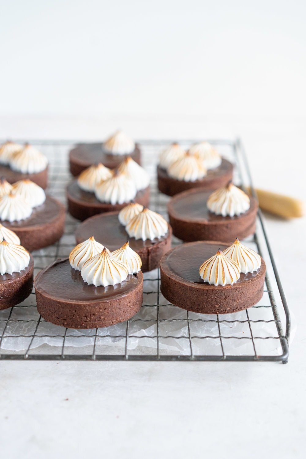 Dark Chocolate Peanut Butter Mini Tarts with Mixed Berry Jam, Chocolate Crust, and Torched Swiss Meringue #minitart #peanutbutterganache #chocolatetart