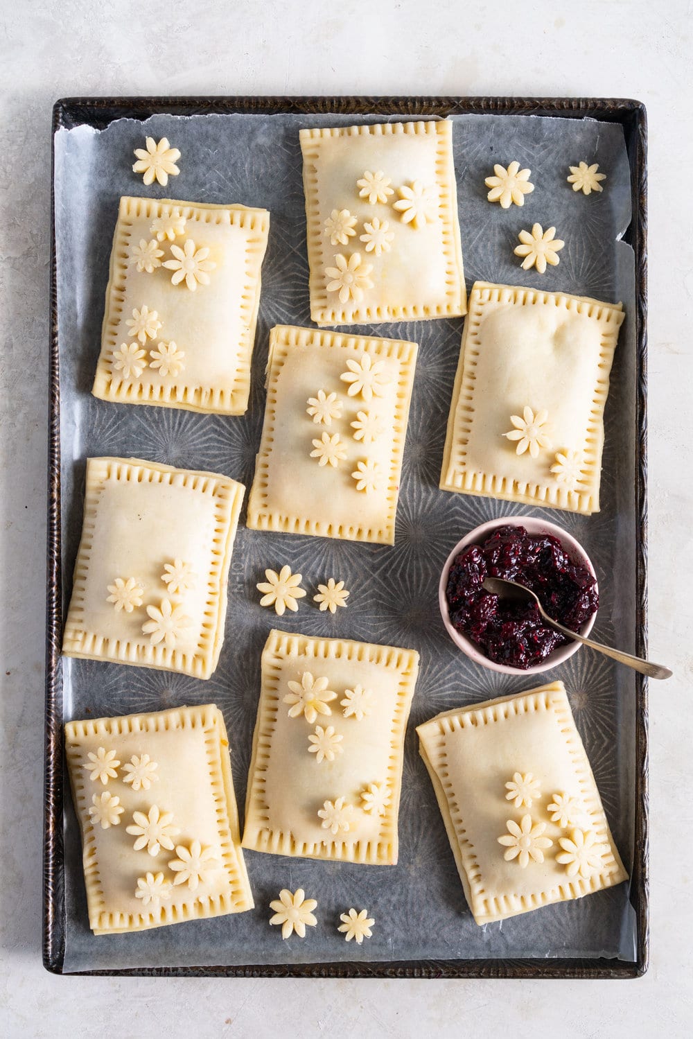 Mixed Berry and Cream Cheese Hand Pies - an easy flaky pie dough encases a mixed berry and vanilla bean cream cheese filling. These miniature pies are perfect for using up surplus cream cheese or jam that you may have, or for making use of slightly sad or tired berries. #handpies #easyhandpies #mixedberryjam