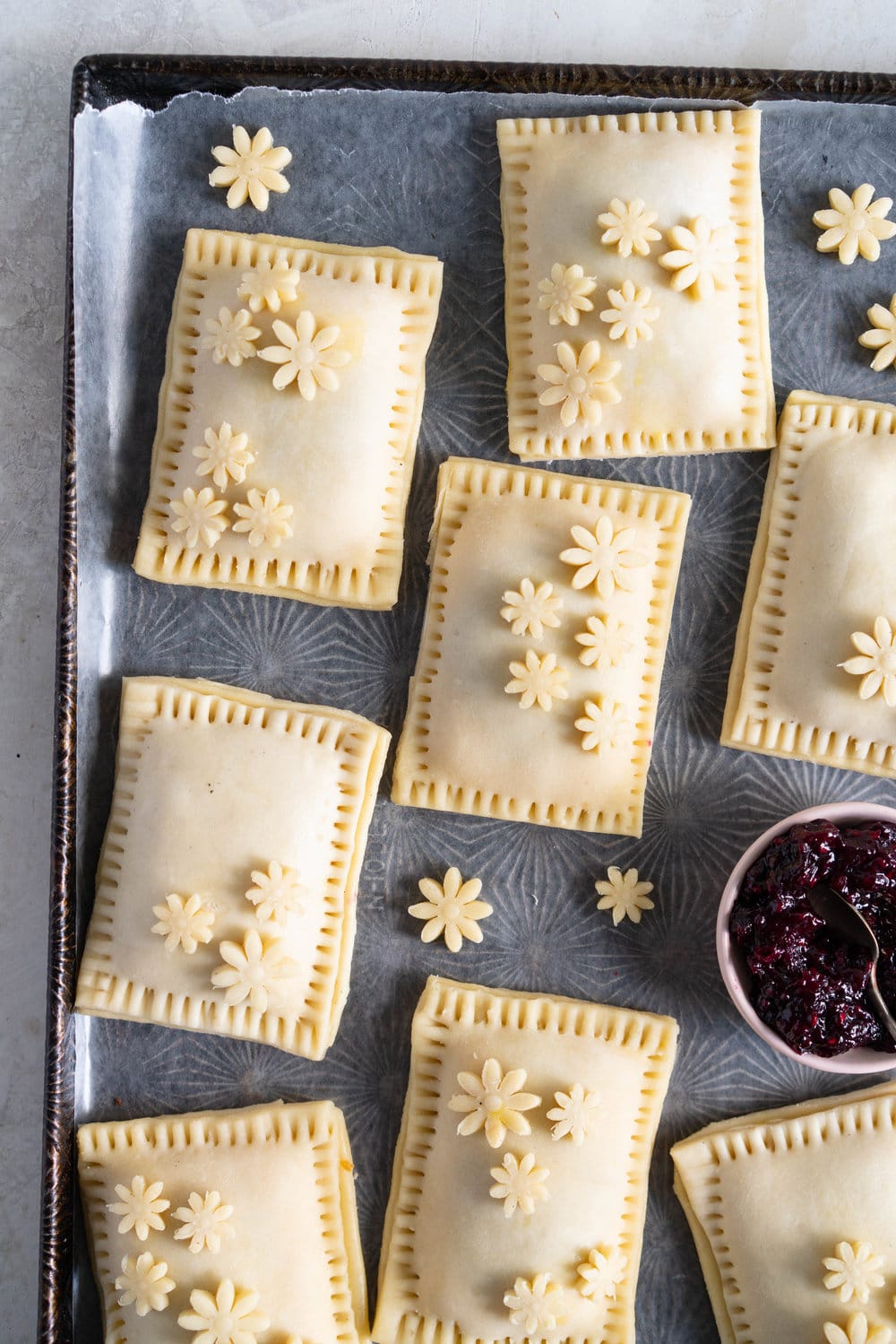 Mixed Berry and Cream Cheese Hand Pies - an easy flaky pie dough encases a mixed berry and vanilla bean cream cheese filling. These miniature pies are perfect for using up surplus cream cheese or jam that you may have, or for making use of slightly sad or tired berries. #handpies #easyhandpies #mixedberryjam