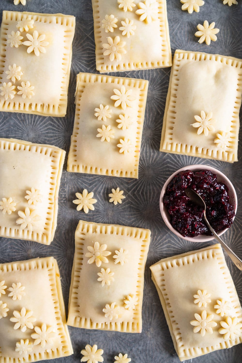 Mixed Berry and Cream Cheese Hand Pies - an easy flaky pie dough encases a mixed berry and vanilla bean cream cheese filling. These miniature pies are perfect for using up surplus cream cheese or jam that you may have, or for making use of slightly sad or tired berries. #handpies #easyhandpies #mixedberryjam