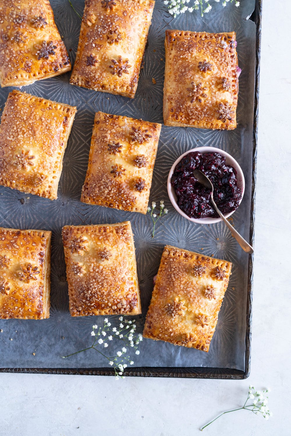 Mixed Berry and Cream Cheese Hand Pies - an easy flaky pie dough encases a mixed berry and vanilla bean cream cheese filling. These miniature pies are perfect for using up surplus cream cheese or jam that you may have, or for making use of slightly sad or tired berries. #handpies #easyhandpies #mixedberryjam