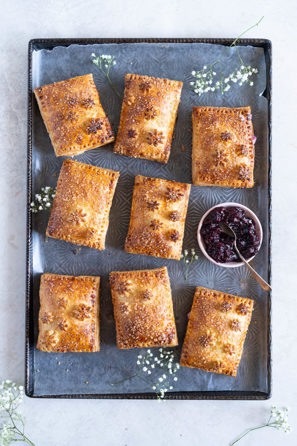 Mixed Berry and Cream Cheese Hand Pies - an easy flaky pie dough encases a mixed berry and vanilla bean cream cheese filling. These miniature pies are perfect for using up surplus cream cheese or jam that you may have, or for making use of slightly sad or tired berries. #handpies #easyhandpies #mixedberryjam