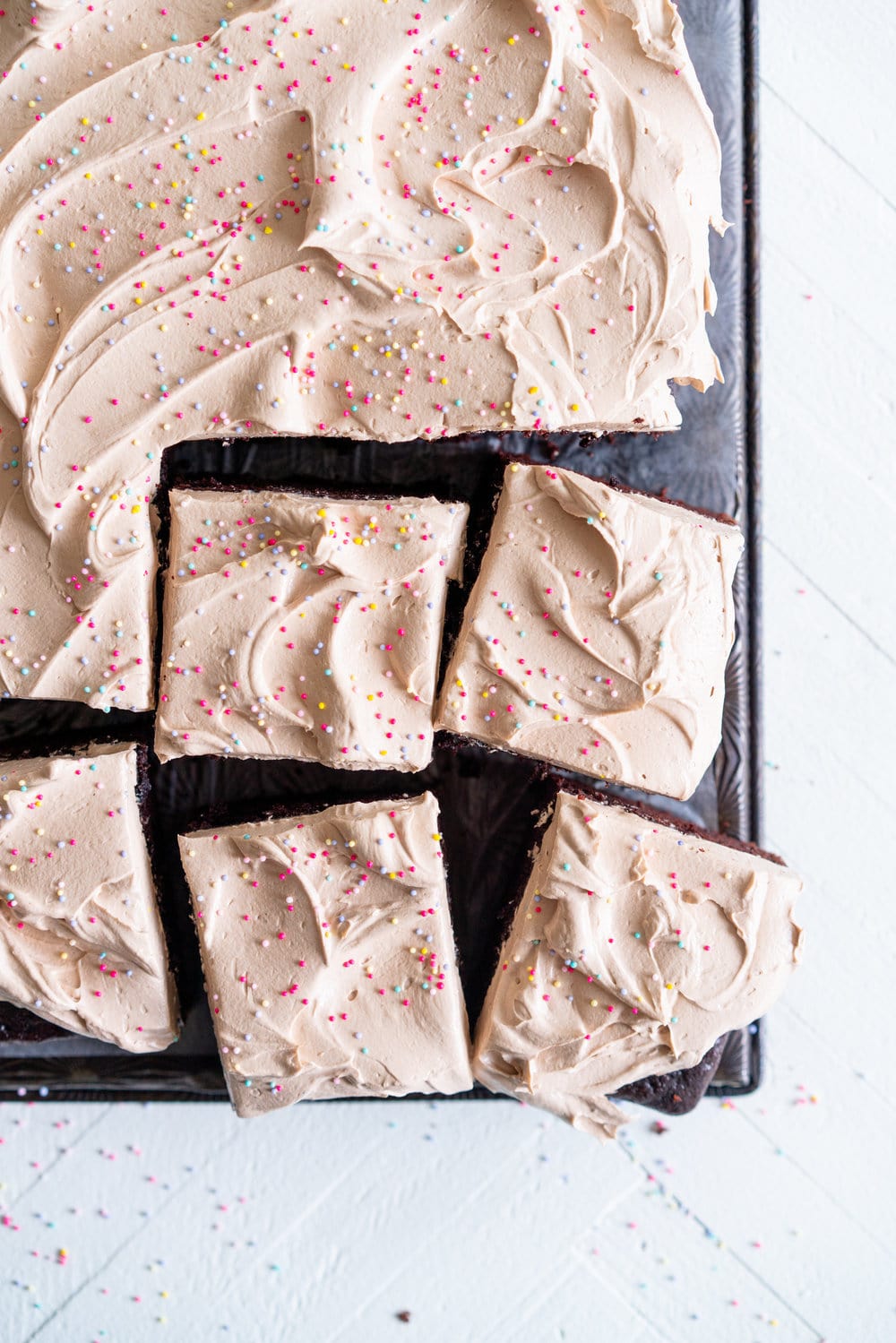 Chocolate sheet cake with milk chocolate german buttercream. This easy, from scratch chocolate sheet cake is enhanced with the flavour of olive oil, and bakes up nice and flat, making it the perfect sheet cake for decorating. It is topped with a silky, milk chocolate german buttercream. #sheetcake #germanbuttercream #chocolateoliveoilcake