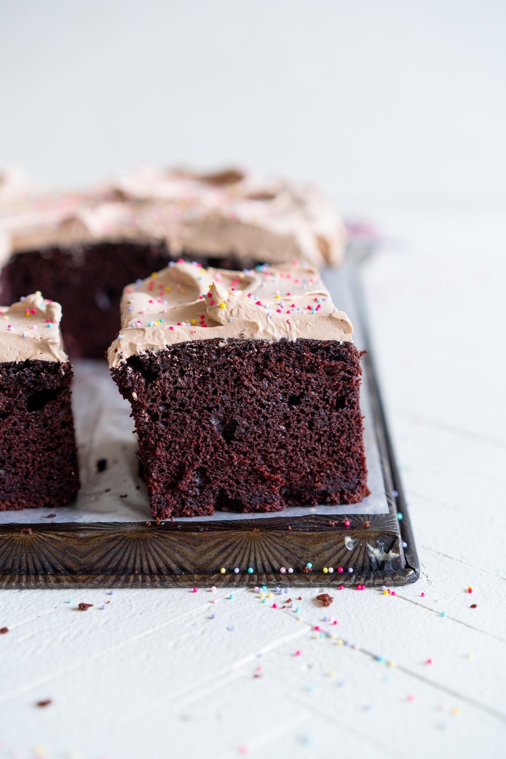 Chocolate sheet cake with milk chocolate german buttercream. This easy, from scratch chocolate sheet cake is enhanced with the flavour of olive oil, and bakes up nice and flat, making it the perfect sheet cake for decorating. It is topped with a silky, milk chocolate german buttercream. #sheetcake #germanbuttercream #chocolateoliveoilcake