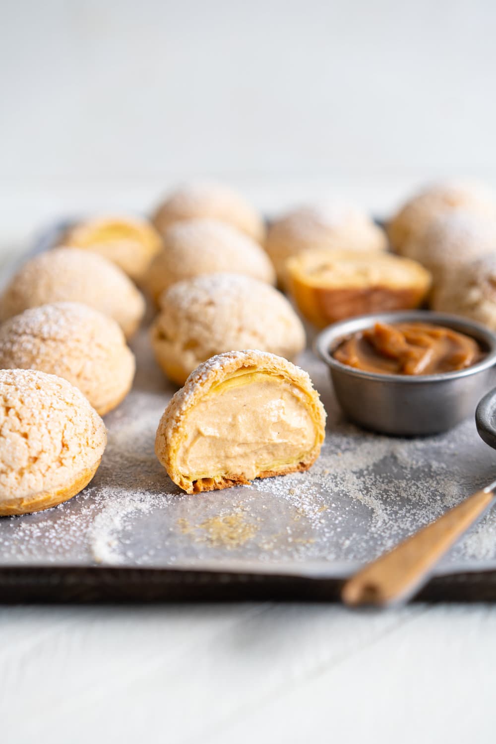 Golden Sugar Choux au Craquelin - Cream Puffs with Salted Caramel Diplomat Cream. These easy cream puffs, topped with crispy craquelin, are stuffed full with a salted caramel pastry cream, which is folded into softly whipped cream to form salted caramel diplomat cream. #creampuffs #chouxaucraquelin #saltedcaramel #diplomatcream