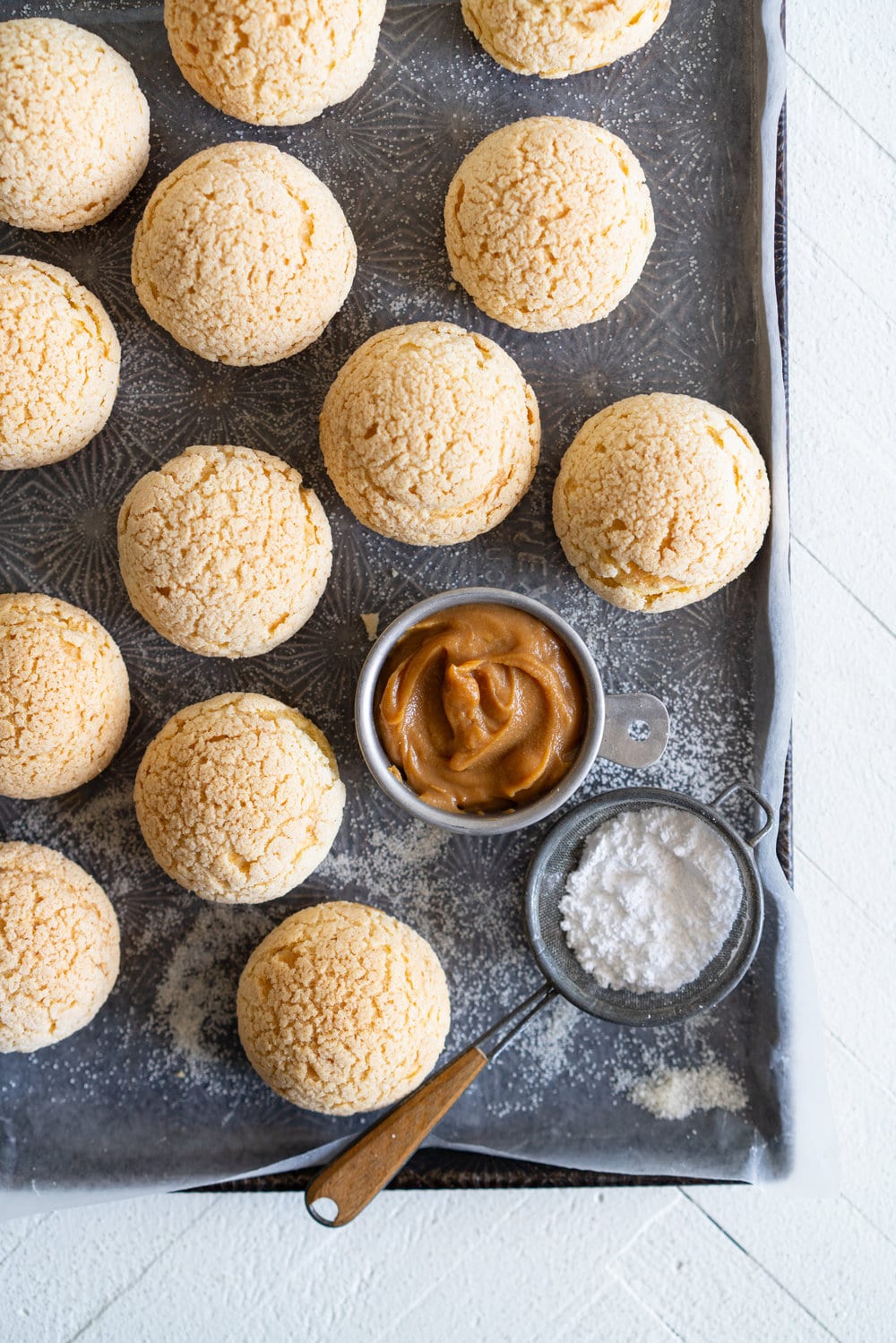 Golden Sugar Choux au Craquelin - Cream Puffs with Salted Caramel Diplomat Cream. These easy cream puffs, topped with crispy craquelin, are stuffed full with a salted caramel pastry cream, which is folded into softly whipped cream to form salted caramel diplomat cream. #creampuffs #chouxaucraquelin #saltedcaramel #diplomatcream