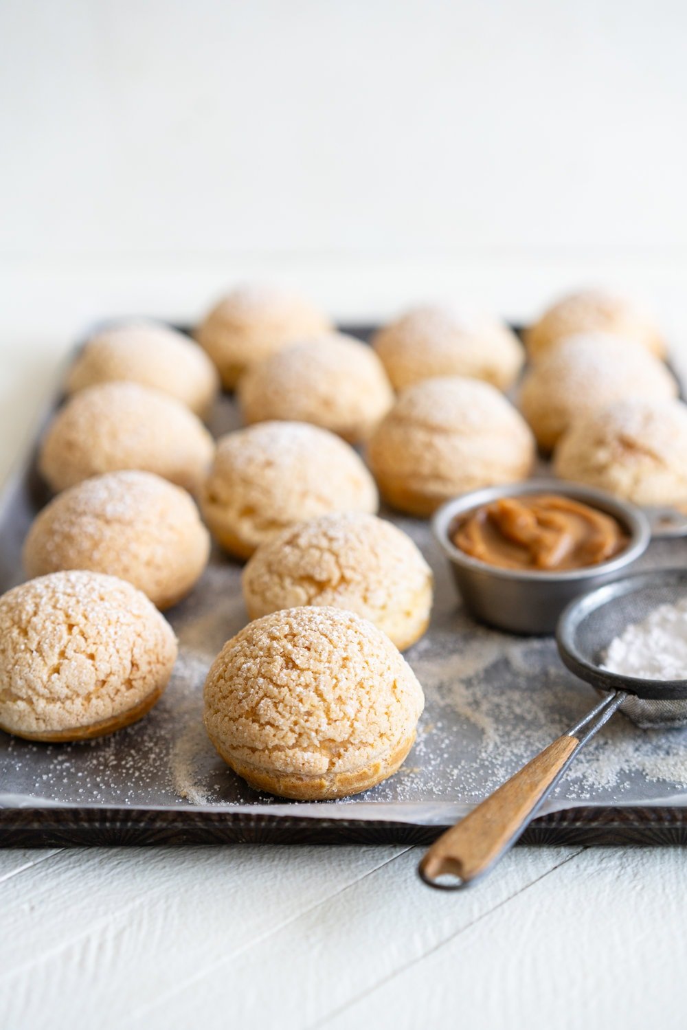 Golden Sugar Choux au Craquelin - Cream Puffs with Salted Caramel Diplomat Cream. These easy cream puffs, topped with crispy craquelin, are stuffed full with a salted caramel pastry cream, which is folded into softly whipped cream to form salted caramel diplomat cream. #creampuffs #chouxaucraquelin #saltedcaramel #diplomatcream