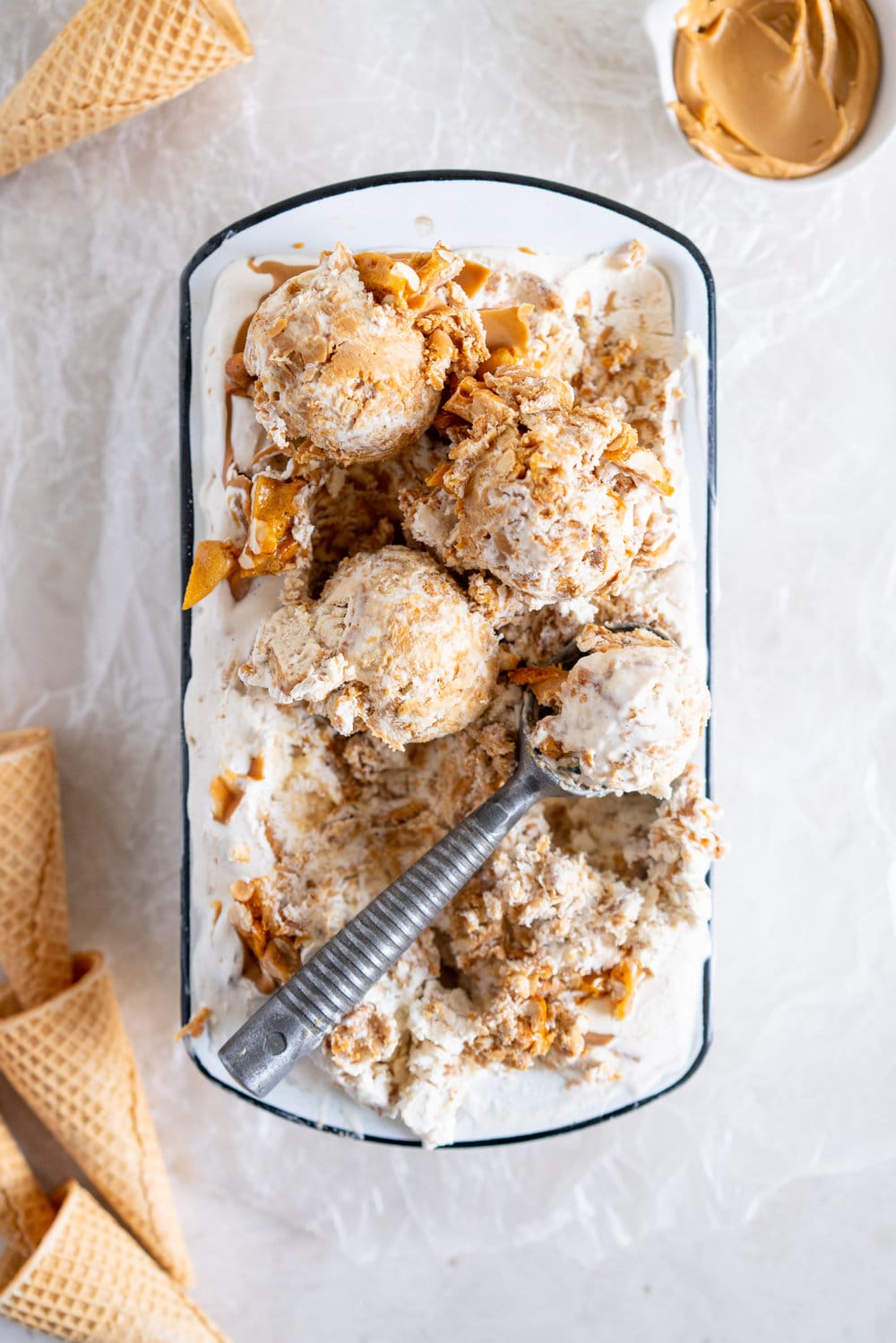 Peanut Butter Ripple Philadelphia Style Ice Cream with Peanut Brittle and Pretzels. This extra chunky philadelphia style ice cream is filled with crunchy peanut brittle, salty pretzels, and a creamy peanut butter swirl, making it the perfect treat for peanut butter lovers! #peanutbuttericecream #vanillaicecream #peanutbrittle #pretzelicecream