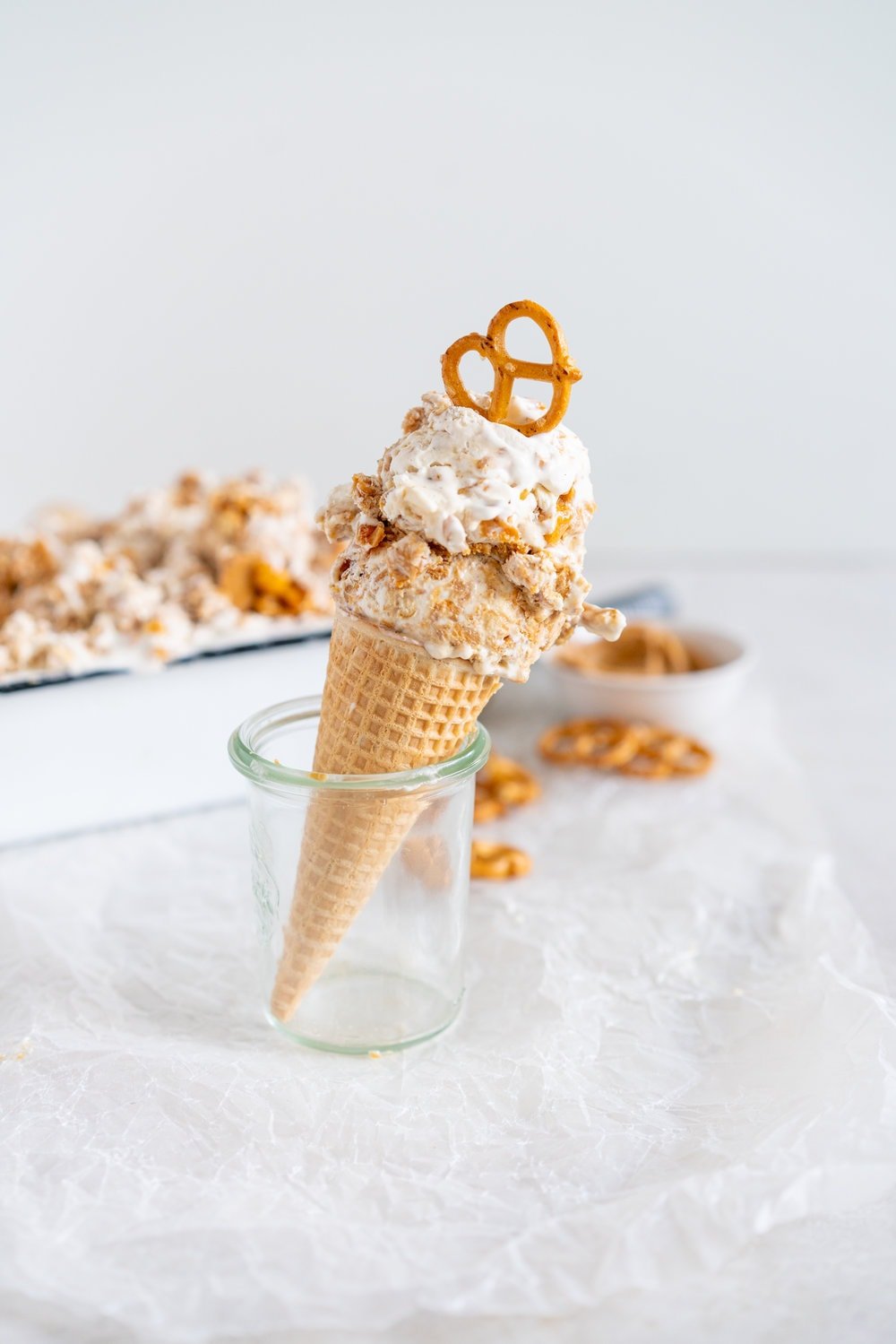Peanut Butter Ripple Philadelphia Style Ice Cream with Peanut Brittle and Pretzels. This extra chunky philadelphia style ice cream is filled with crunchy peanut brittle, salty pretzels, and a creamy peanut butter swirl, making it the perfect treat for peanut butter lovers! #peanutbuttericecream #vanillaicecream #peanutbrittle #pretzelicecream