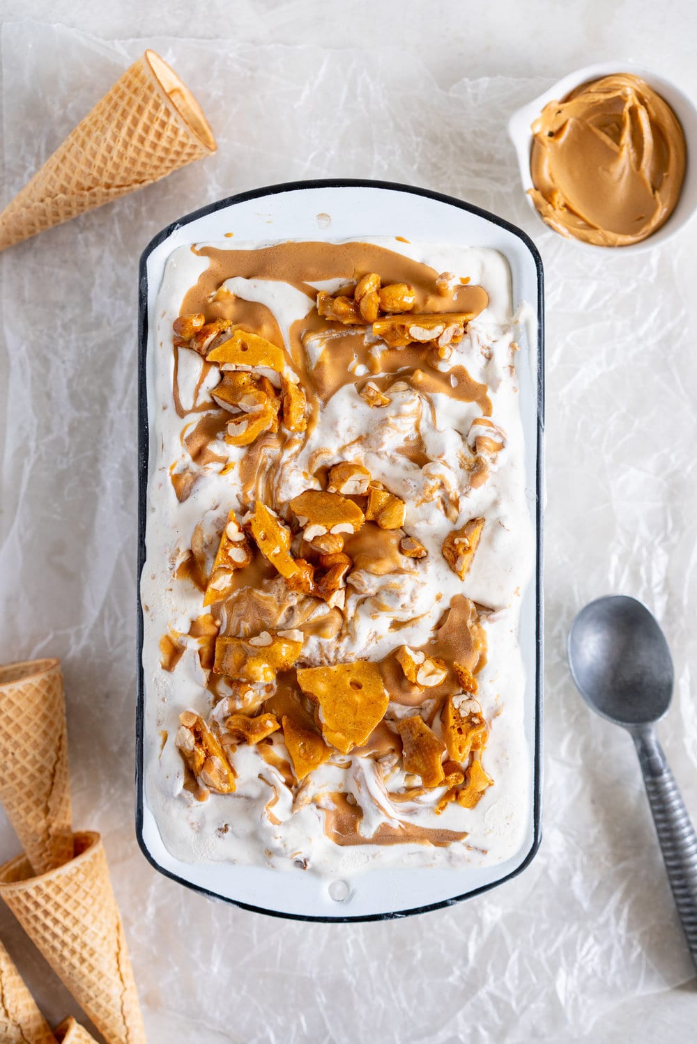 Peanut Butter Ripple Philadelphia Style Ice Cream with Peanut Brittle and Pretzels. This extra chunky philadelphia style ice cream is filled with crunchy peanut brittle, salty pretzels, and a creamy peanut butter swirl, making it the perfect treat for peanut butter lovers! #peanutbuttericecream #vanillaicecream #peanutbrittle #pretzelicecream