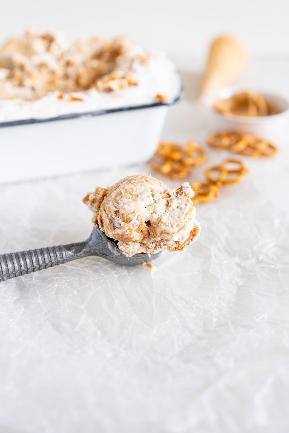 Peanut Butter Ripple Philadelphia Style Ice Cream with Peanut Brittle and Pretzels. This extra chunky philadelphia style ice cream is filled with crunchy peanut brittle, salty pretzels, and a creamy peanut butter swirl, making it the perfect treat for peanut butter lovers! #peanutbuttericecream #vanillaicecream #peanutbrittle #pretzelicecream