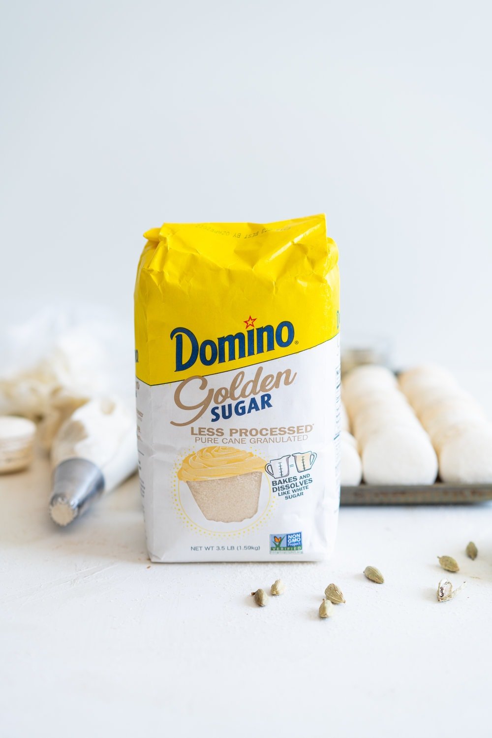 Golden Sugar Macarons with Cardamom Cream Cheese Filling. These French macarons are made with golden sugar, sprinkled with the sugar to give them a sparkly top, and filled with a smooth cardamom cream cheese filling. These are an easy gluten free treat, and this is a great go-to macaron recipe, filled with tips and tricks to help you master french macarons! #frenchmacarons #goldensugar #cardamomcreamcheese