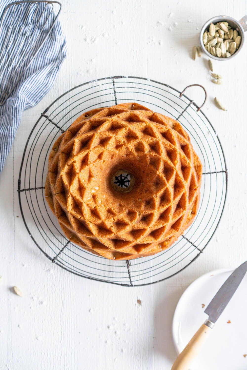 Cardamom Bundt Cake with Cardamom Syrup glaze - this super versatile cardamom sour cream cake is full of warming cardamom spices, both from within the cake and from the simple cardamom bundt syrup glaze that is brushed on top. You can leave the cardamom out for a perfect vanilla sour cream bundt cake, or leave it in there for a cozy, warming bundt cake. #bundtcake #bundtrecipe #cardamombuntcake