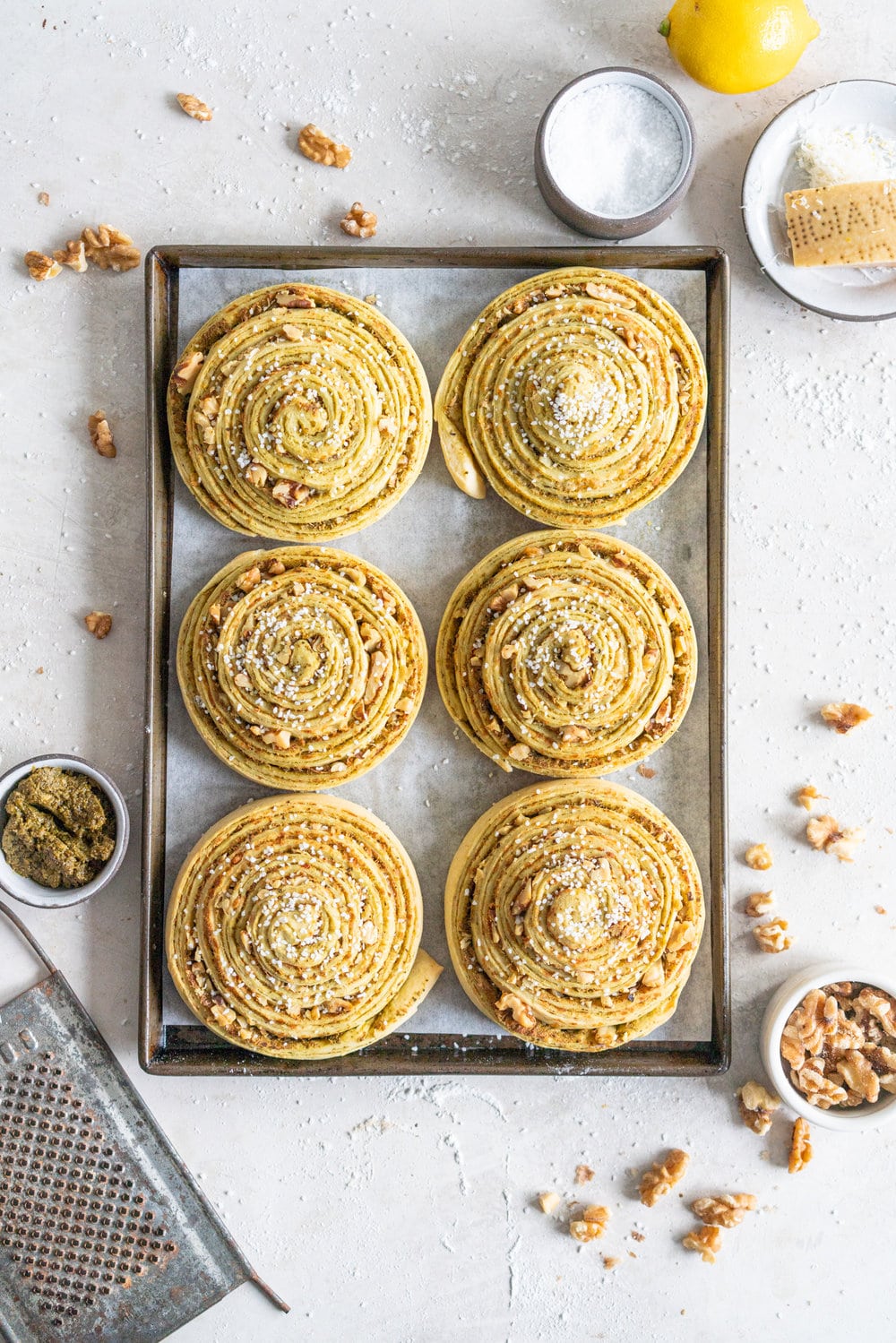 Laminated Brioche Pesto Buns with Lemon, Parmesan, and Walnut - buttery brioche is layered with zesty lemon, basil pesto and cheese, then sprinkled with walnuts and rolled up in to perfect pesto brioche pinwheel rolls. These are the perfect savoury take on a traditional laminated brioche #briocherolls #pestorolls #laminatedbrioche